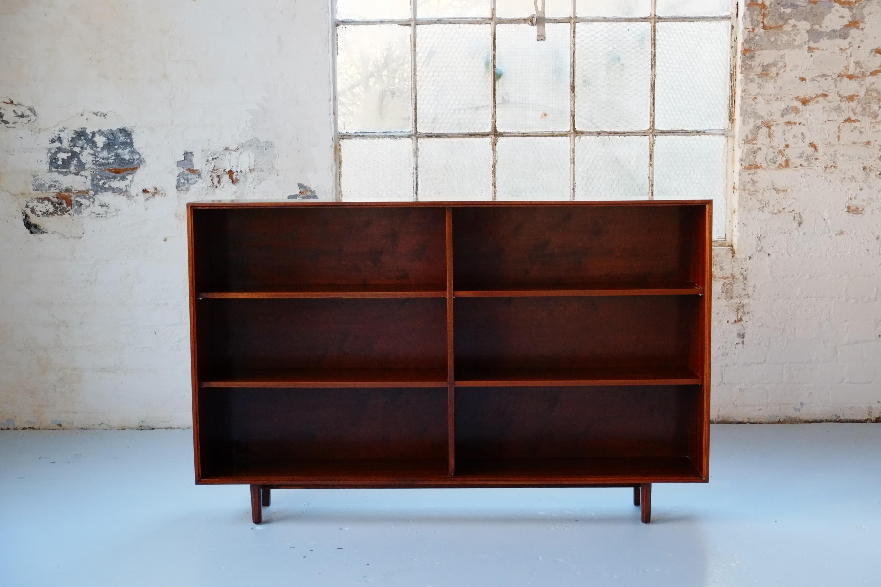 A beautiful long slim glazed bookcase from the 1960s. This Mid-century modern cabinet was designed by Robert Heritage as part of the Multi-Width series for Beaver and Tapley. Beaver and Tapley was a mid-century British furniture manufacturing
