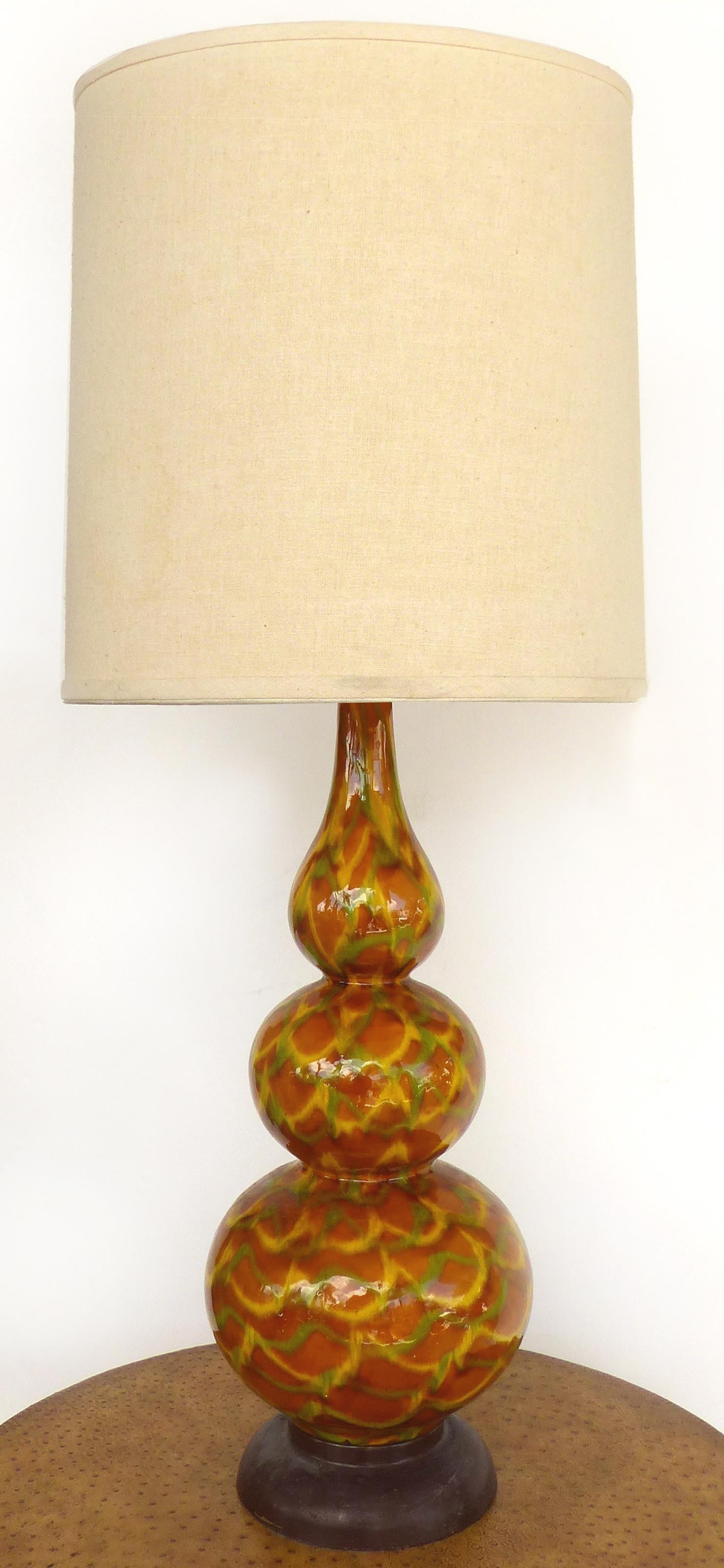 Mid-Century Modern glazed ceramic table lamps

Offered for sale is a pair of glazed ceramic Mid-Century Modern table lamps. Both lamps are wired and in working condition. Shades pictured are not included. The lamps have a single socket which