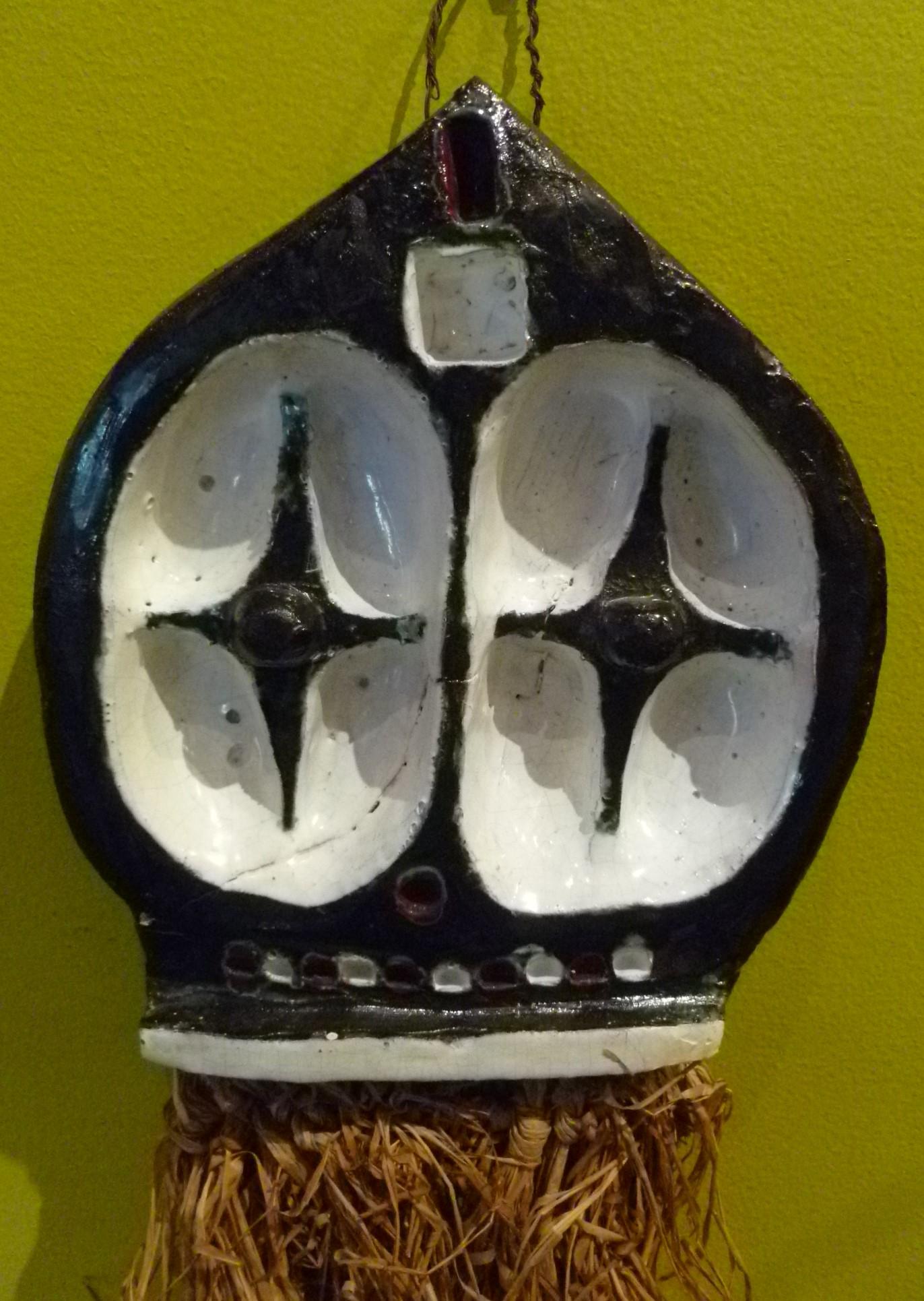 From the 1950s, a pottery wall hanging of a stylized African mask with Raffia/Straw beard, purchased in a Brussels antique shop in the 1970s. Wonderful depiction of what has been used in Africa for centuries as a way to communicate with the deities
