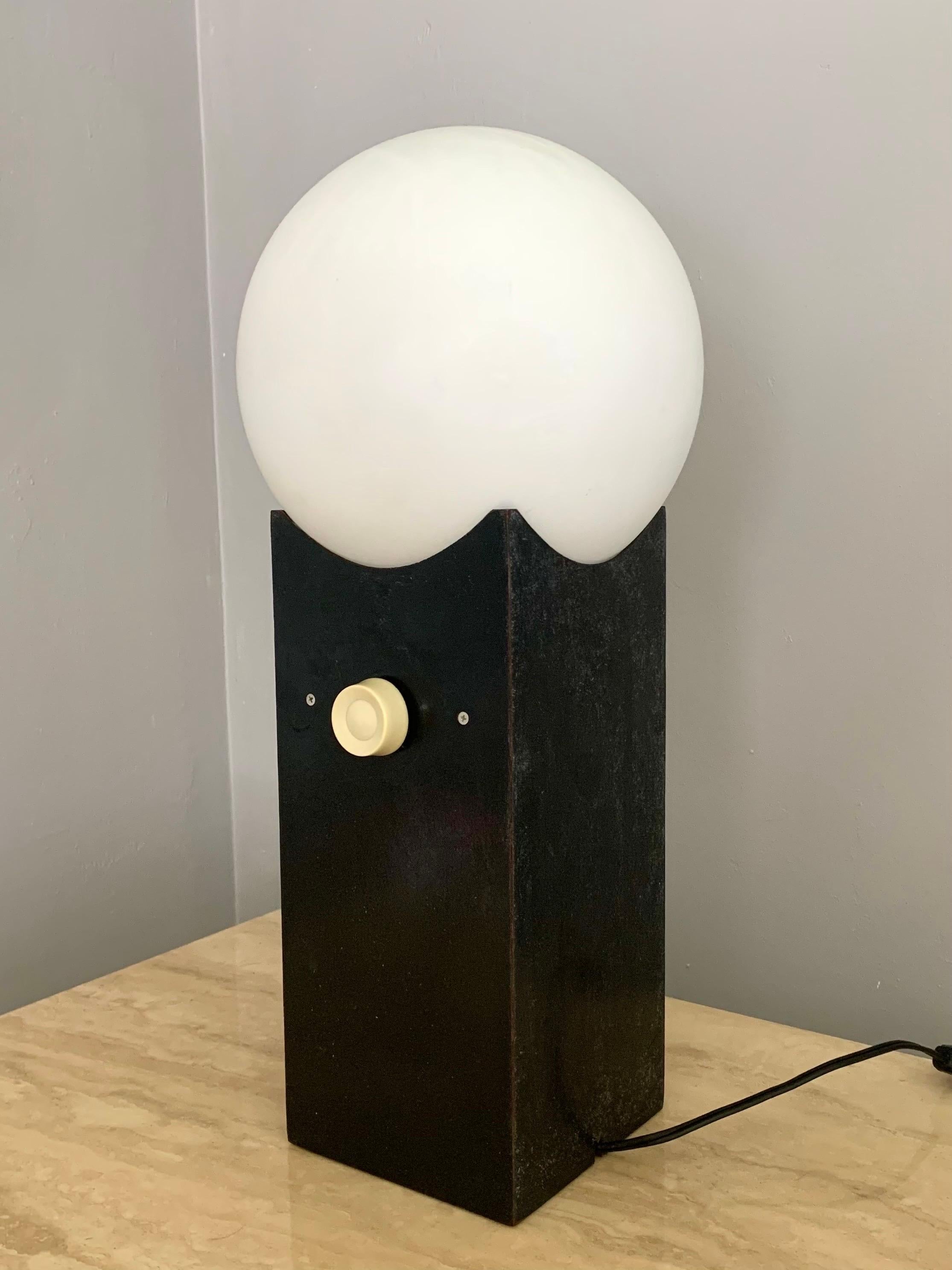 Simple Mid-Century Modern globe lamp. Set on a dimmer switch. Works great. Base made of wood that has a black coating. Great patina and wear patterns. Great minimalist design.

Lamp is 17.5