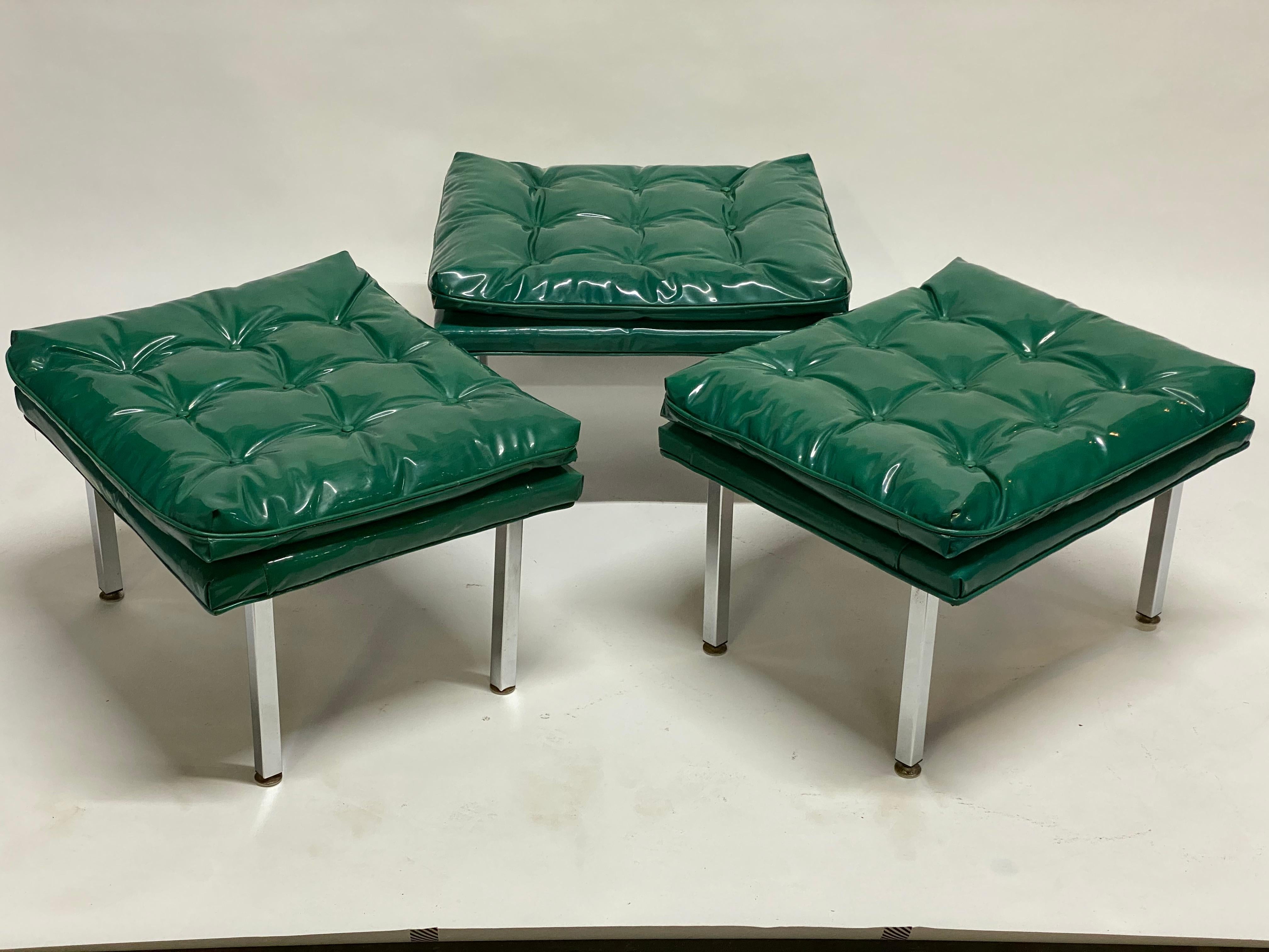 A set of three glossy and bright kelly green tufted vinyl seat benches or stools with squared aluminum legs. circa 1970. Could also possibly be used as ottomans. Great styled together giving a long bench affect or used separately as a distinctly