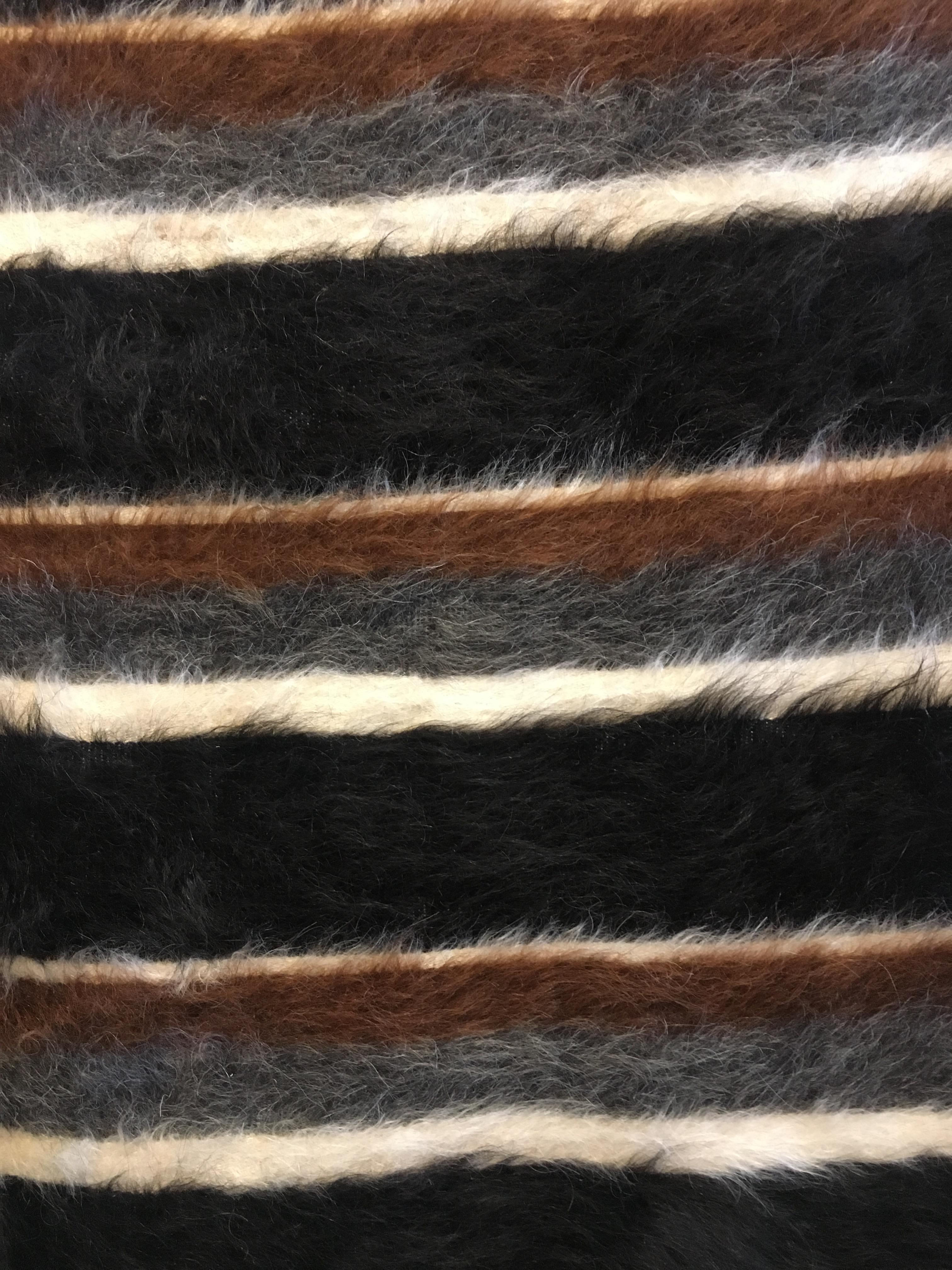 Handwoven in eastern Turkey, this small rug has a cotton foundation and a woven soft goat hair pile using all natural, undyed colors of black brown and ivory. In excellent condition, with a truly great look.