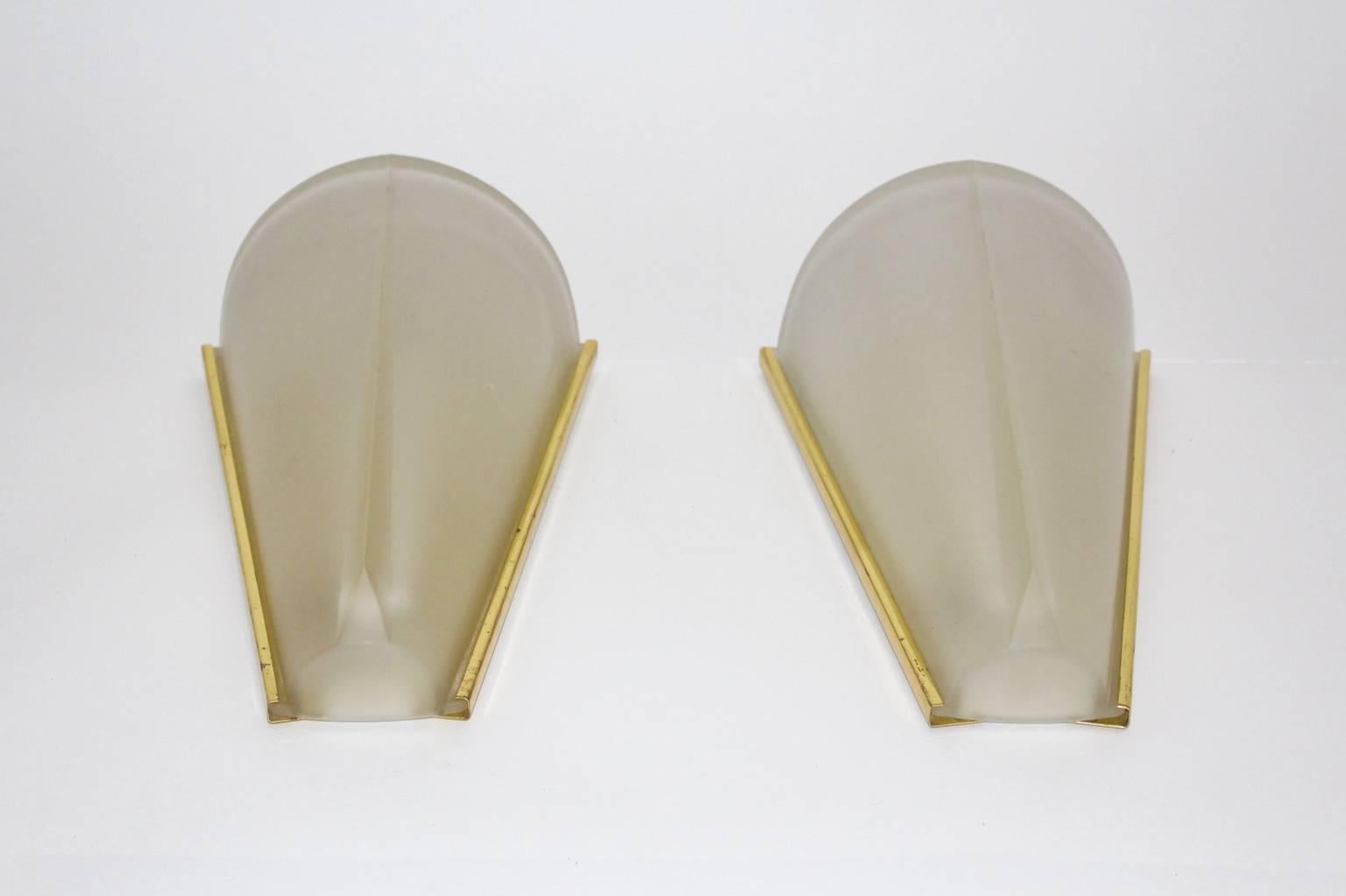 Elegant conical wall lights designed and manufactured in Germany in the 1960s by Hustadt Leuchten Germany.
The brass frames have a lovely vintage patina, while the etched glass shades are in very good condition without any cracks or spots.
Each wall