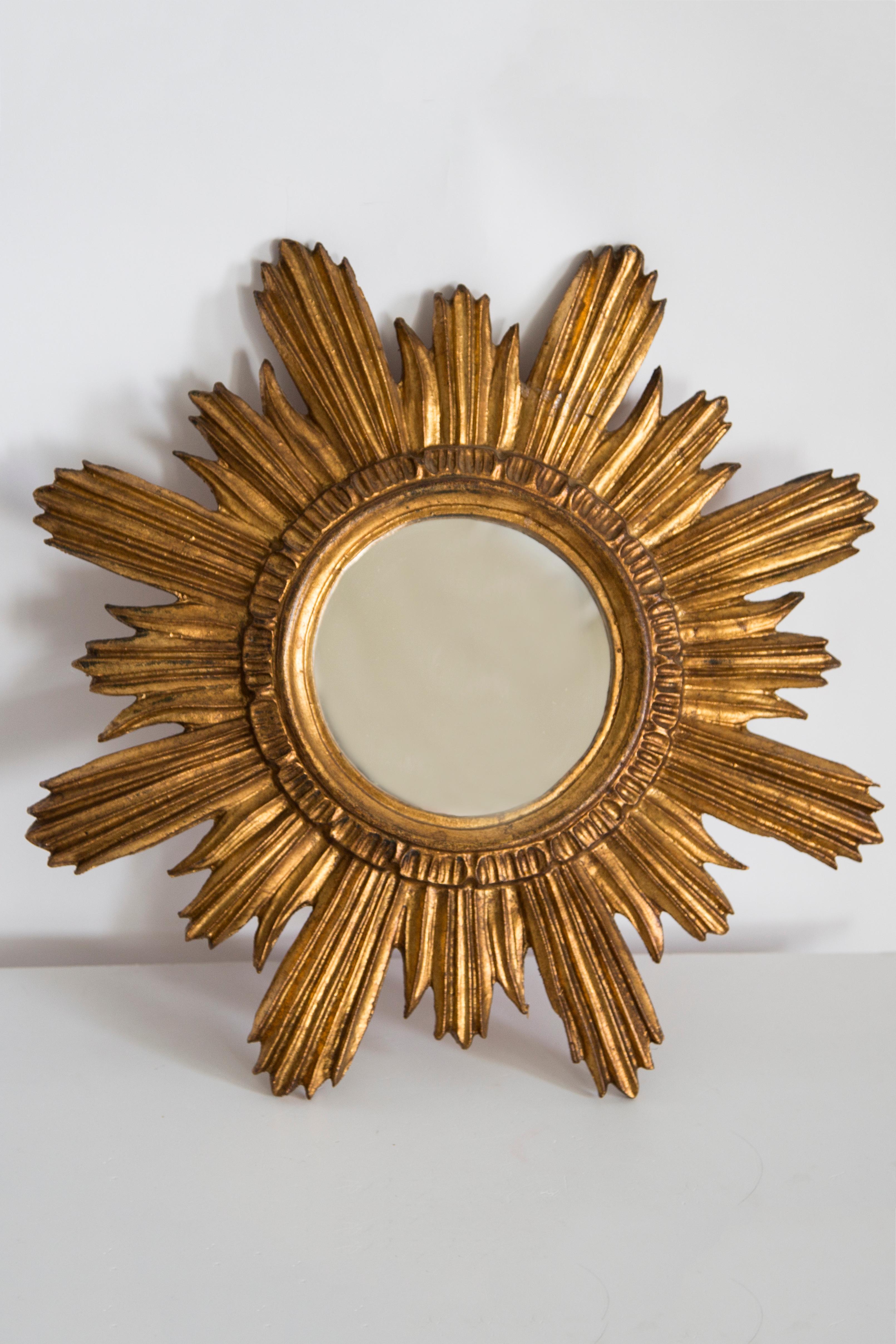 Vintage mirror in a golden decorative sun-shaped frame from Italy. The frame is made of wood. Good original condition, one repair in the frame, the mirror has minimal flaws. All is shown on pictures. Beautiful piece for every interior! Absolutely