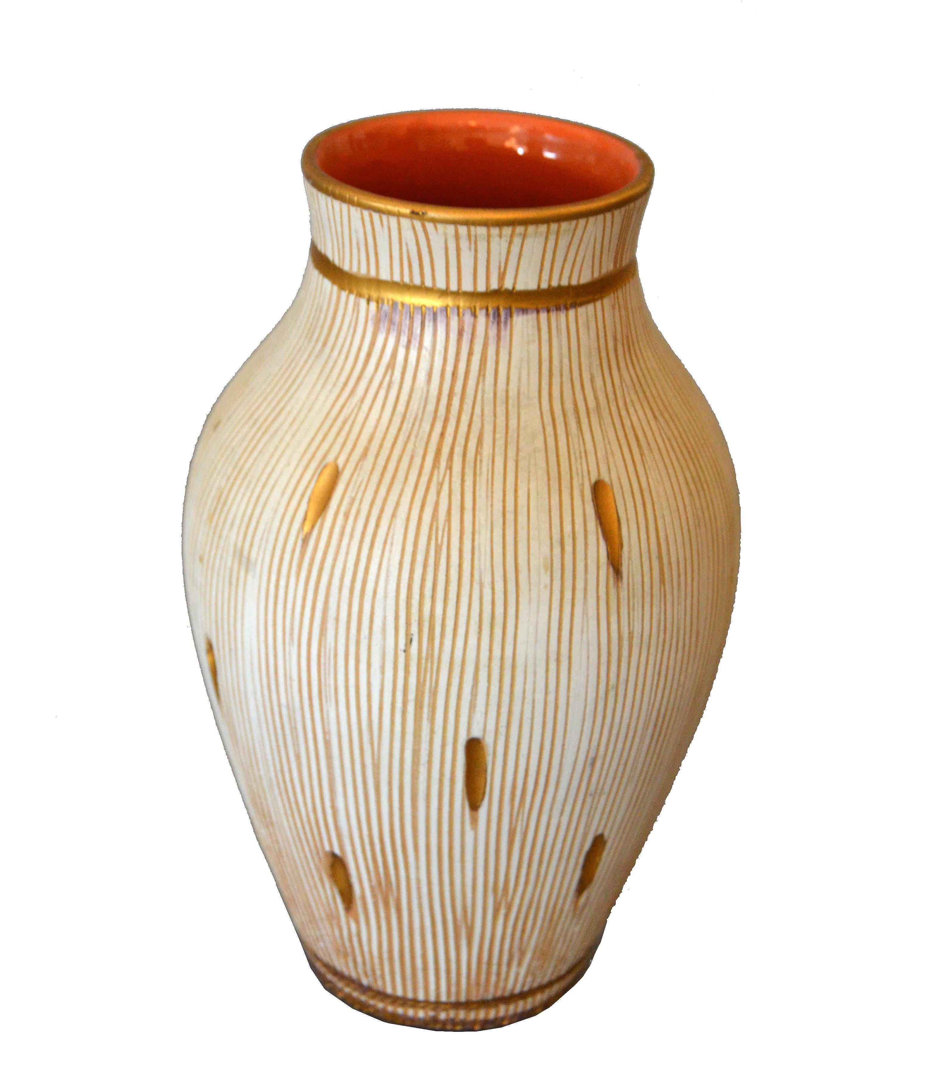 Charming Mid-Century Modern handcrafted ceramic vase in Beige and hand painted with gold leaf.
The inside is glazed in a warm brown tone.
Marked and numbered underneath, Italy, 10-23.