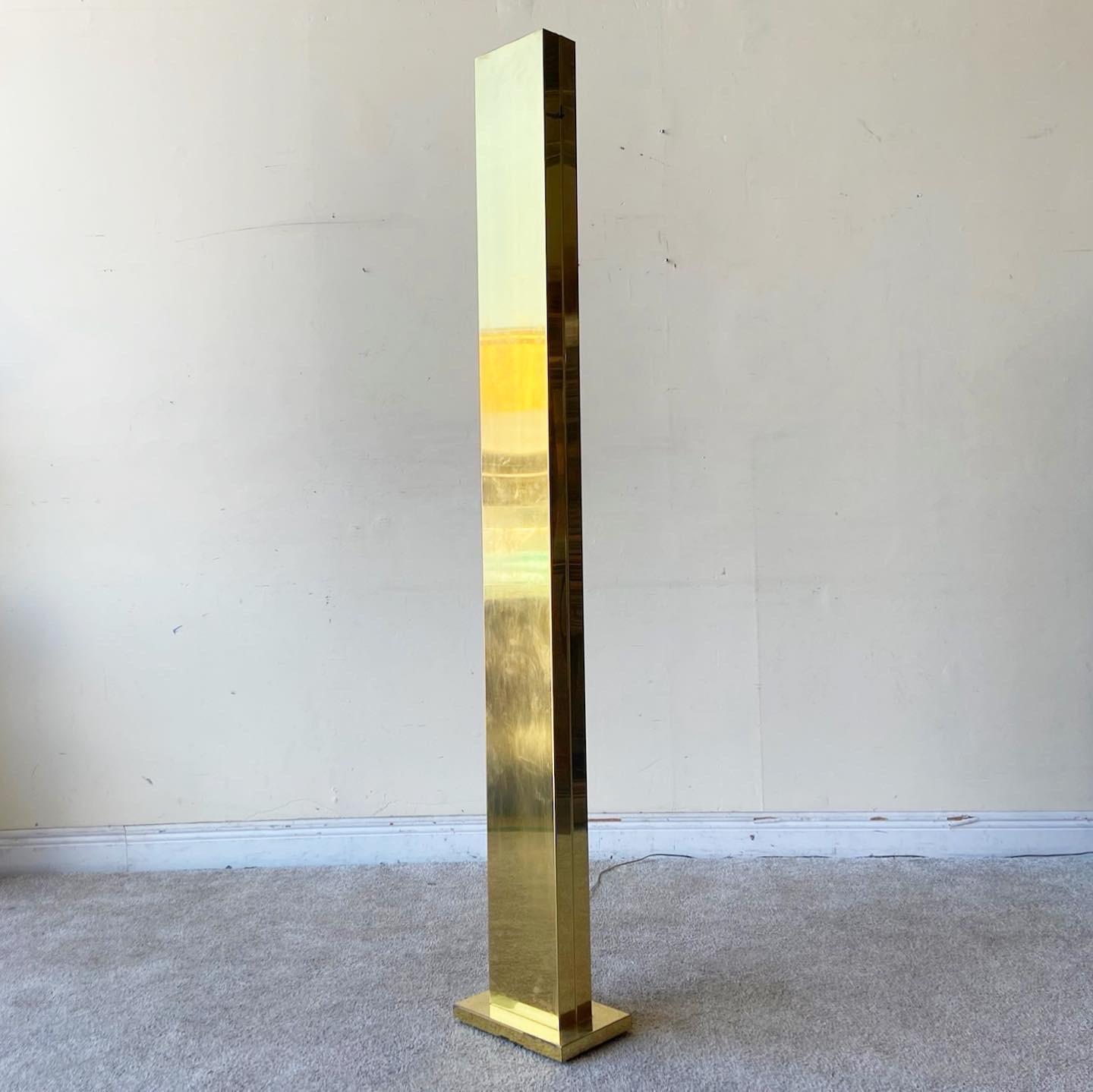 Exceptional mid century modern torch lamp. Features a dimmable light and a gold rectangular body.
