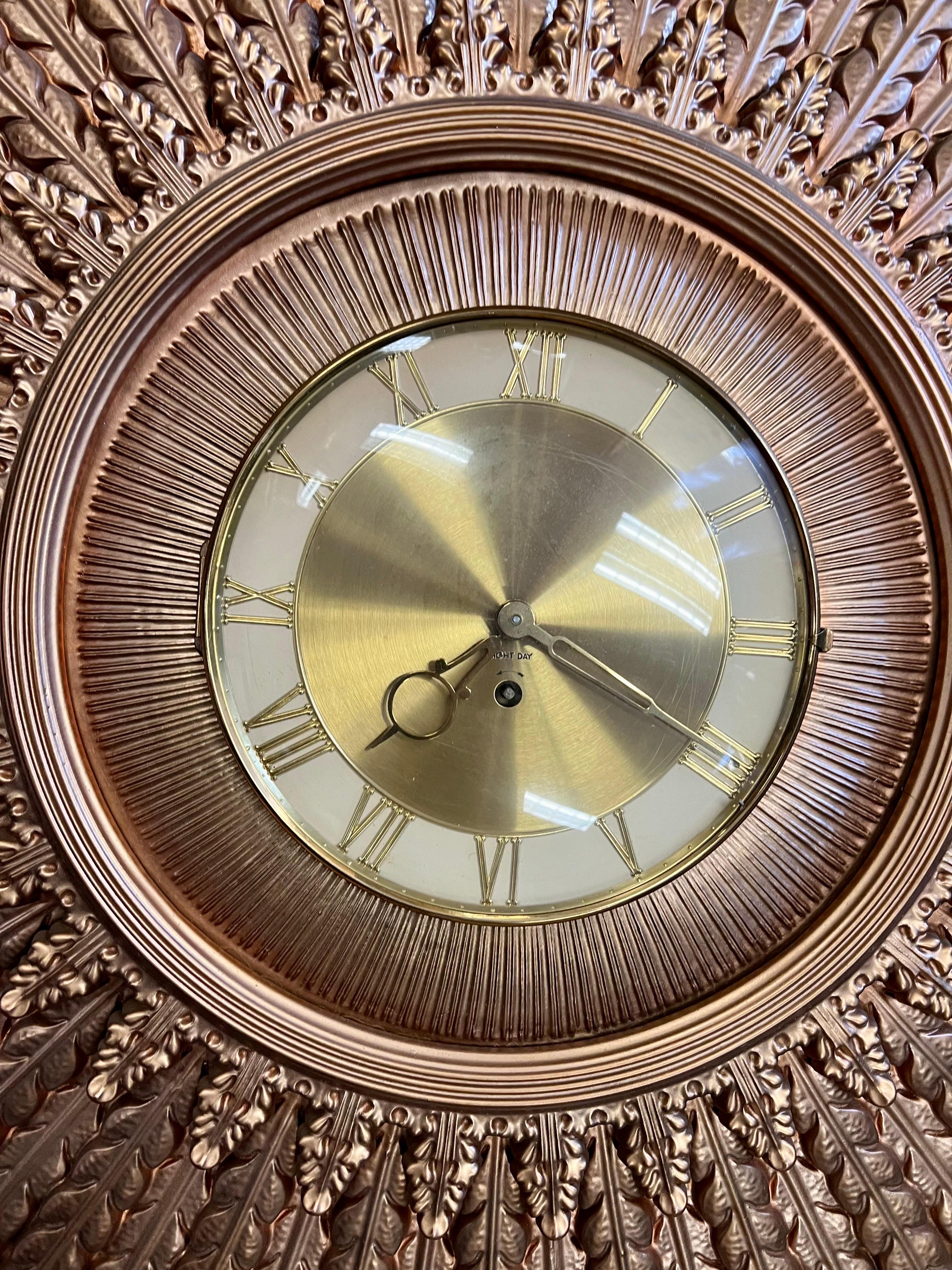 Stunning iconic mid century eight day gold starburst clock with key.  Clocj face has window that opens.