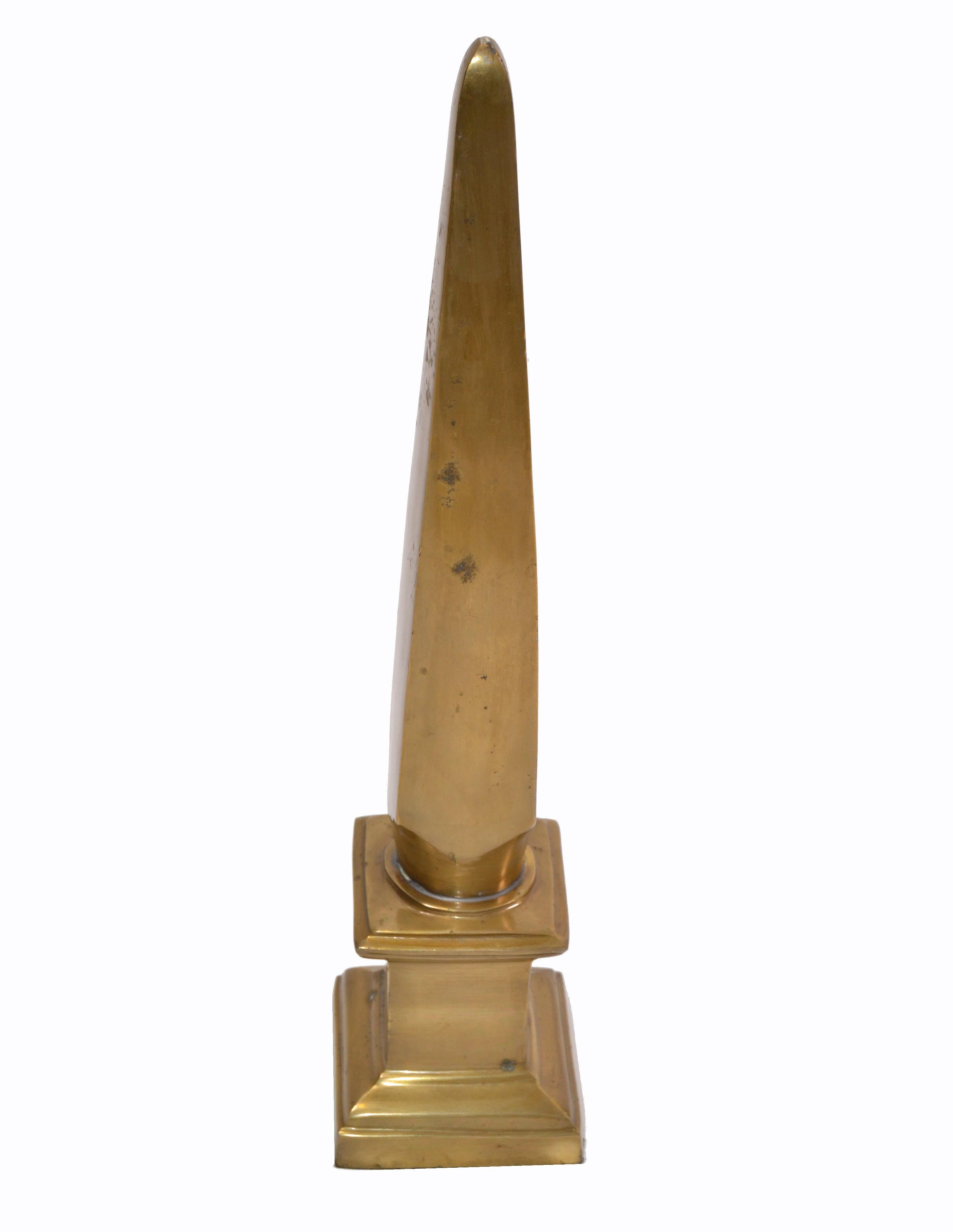 Mid-Century Modern gold tone bronze obelisks.
Looks great as display and also very useful as bookend.
Felt cover underneath.
   