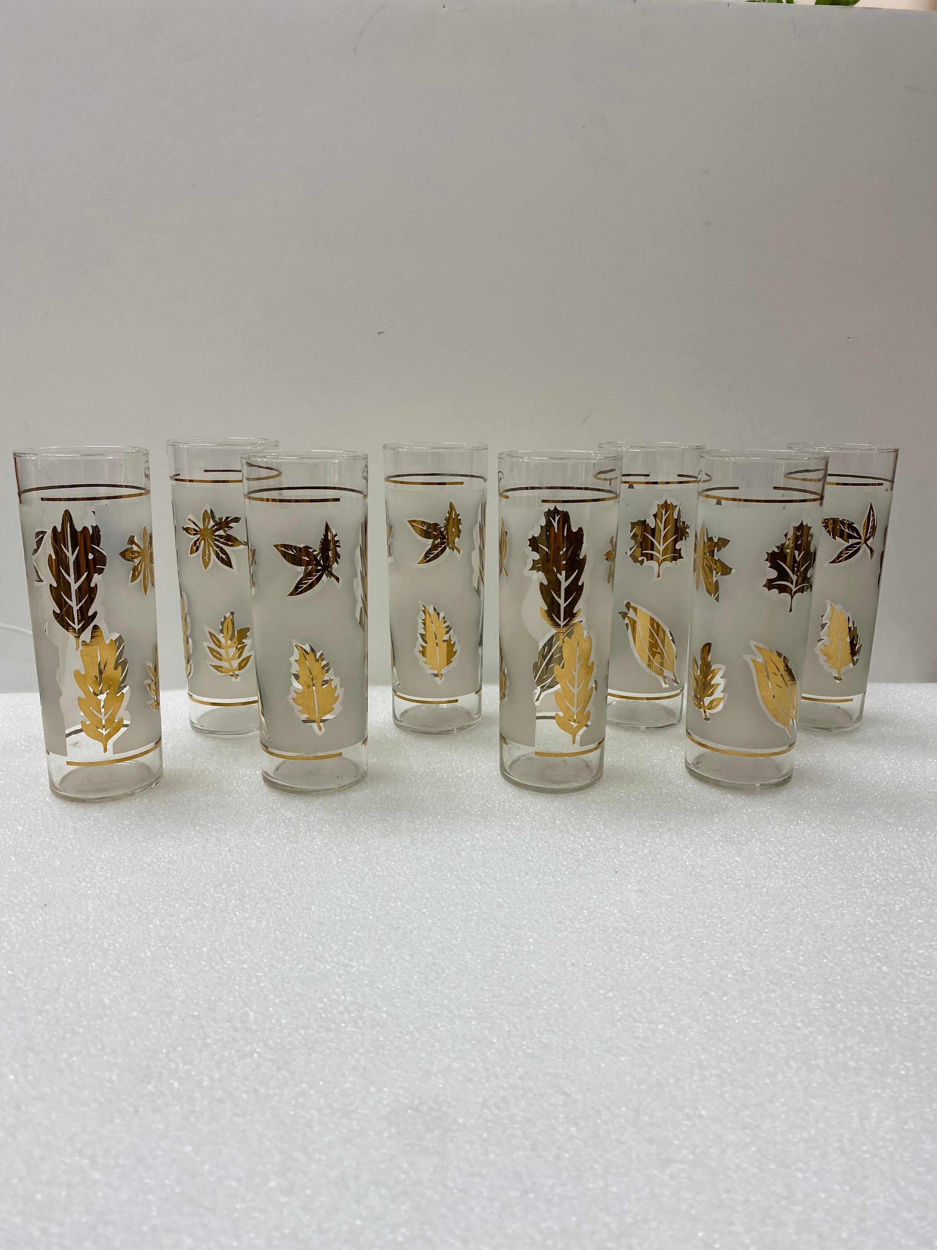 Mid-Century Modern/Hollywood Regency set of eight frosted Libbey highball glasses. This is a wonderful 8 piece barware set created and marketed for the Libbey Glass Company in 1957. The glasses are adorned with 22k gold embellished leaves on a