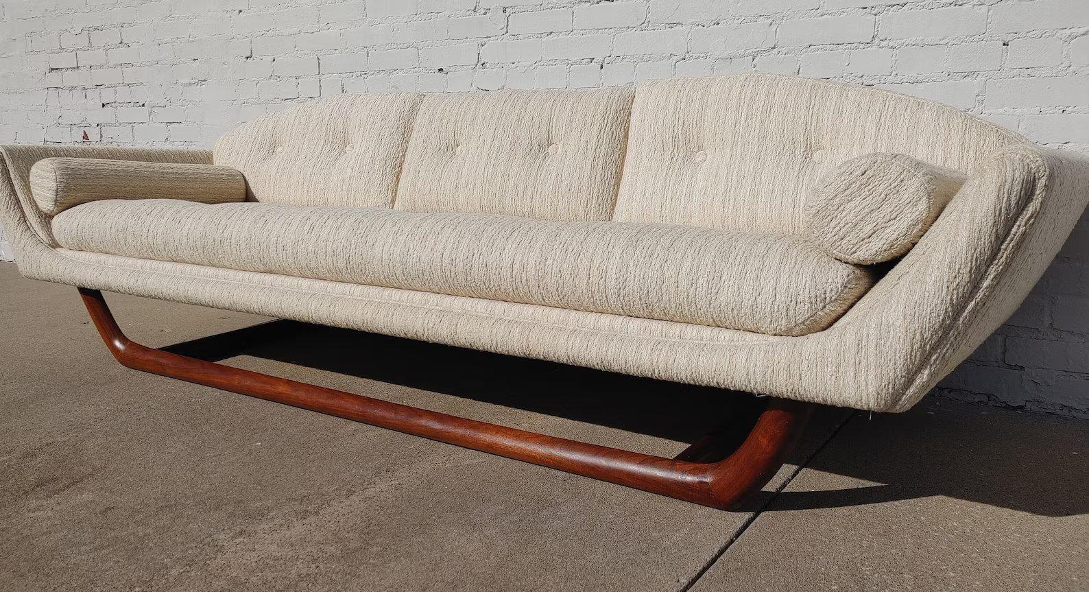 Mid Century Modern Gondola Sofa In Manner of Adrian Pearsall

Above average vintage condition and structurally sound. Has some expected slight finish wear on the trim and little if any soiling on the armrests. Has two dime size discolorations on the