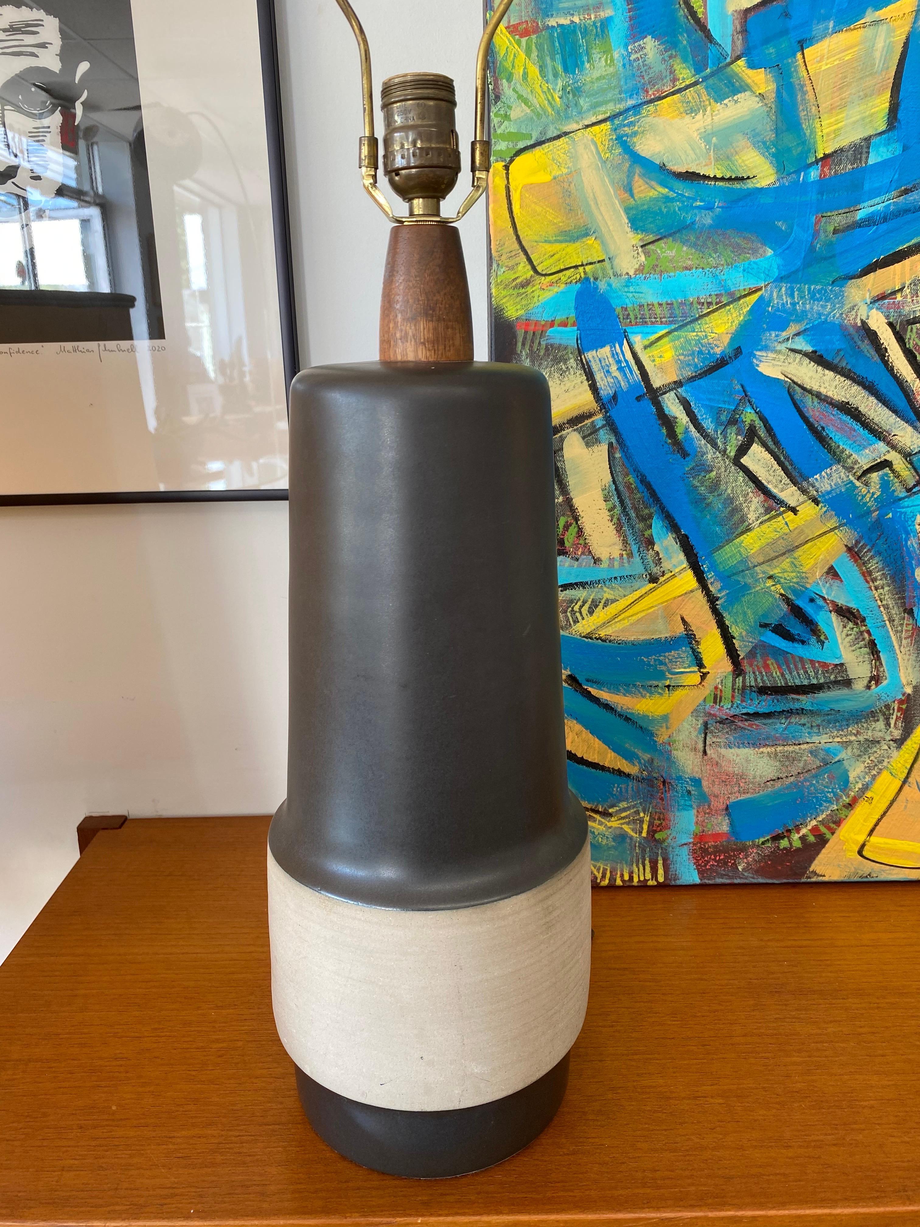 Beautifully understated ceramic lamp by Gordon & Jane Martz, circa 1960s.The lamp has a teak mounting and finial and the lampshade is new. Martz lamp is signed and in great condition. 

Gordon & Jane Martz were among the premier American designers