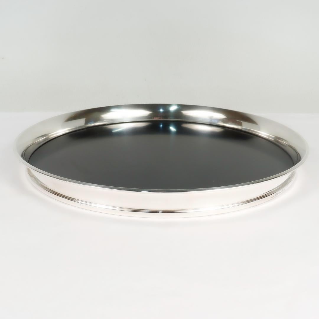 A fine Mid-Century modern bar or cocktail tray.

By Gorham Mfg. Co.

Comprised of a round black laminate base mounted with a round sterling silver rim.

Model no. 1064.

With an original factory sticker to the reverse.

Simply a wonderful