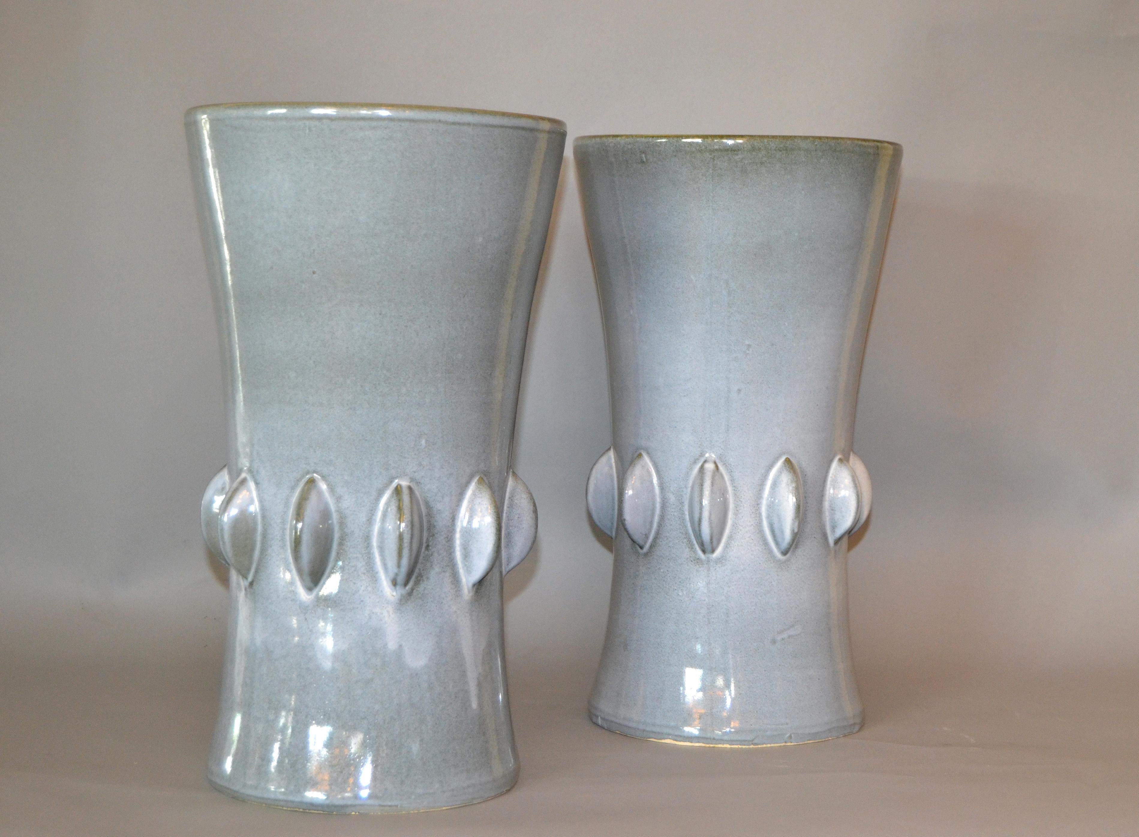 A pair of Mid-Century Modern ceramic vases in light gray dripping glaze.
 
