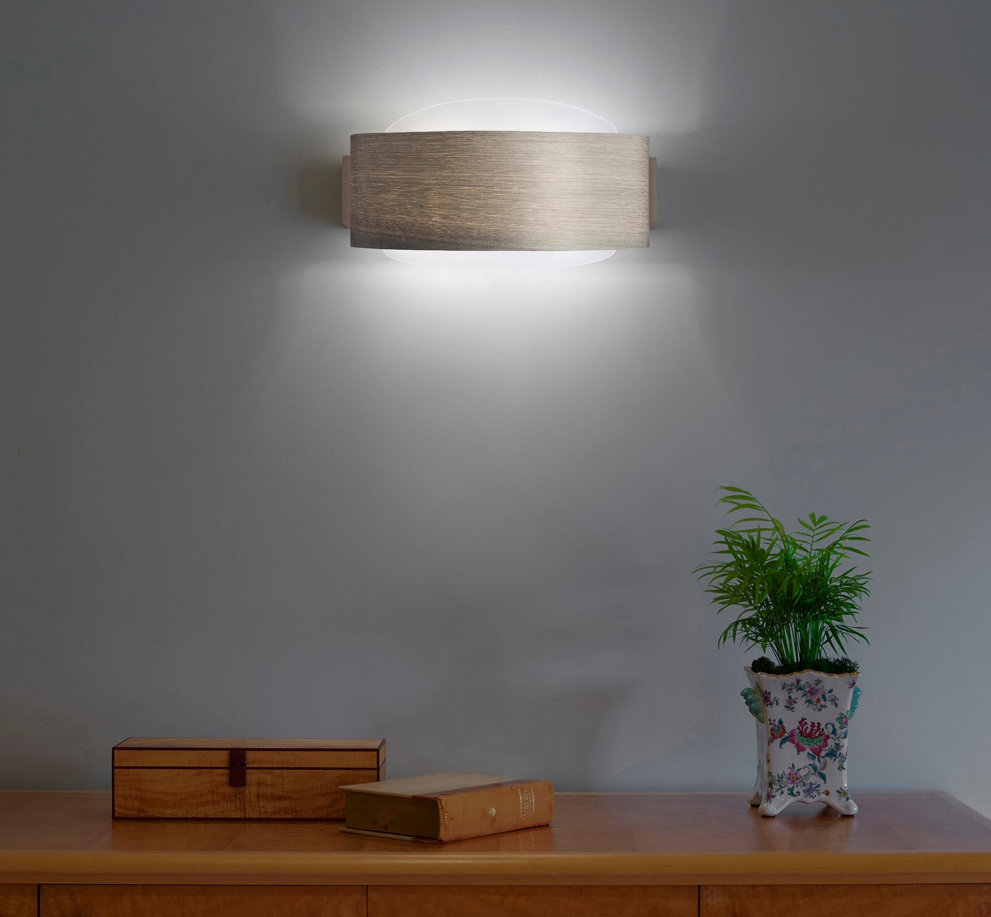 HALO is a Modern sconce that casts perfect, symmetrical light, imbuing a sense of calm and serenity. It can be used as accent lighting, in entryways, hallways, and looks wonderful in sets of two. Gray Tay is harvested from the African Koto tree. The