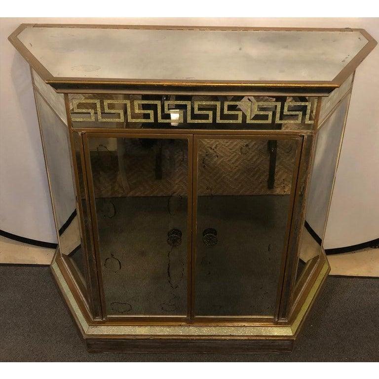 A simply stunning Mid-Century Modern Greek key design all mirrored bar or serving station / cabinet. This fine hard to find bar or serving table depicts the Mid Century era at its finest time. The Greek gold key design timeless in style as this flip