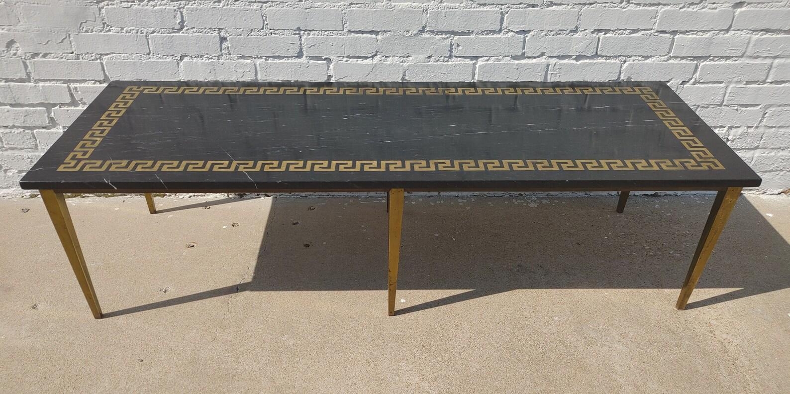 Mid Century Modern Greek Key Marble and Brass Table

Above average vintage condition and structurally sound. Has some expected slight finish wear and scratching. Top has some slight  finish wear and some slight fading in areas. 

Additional