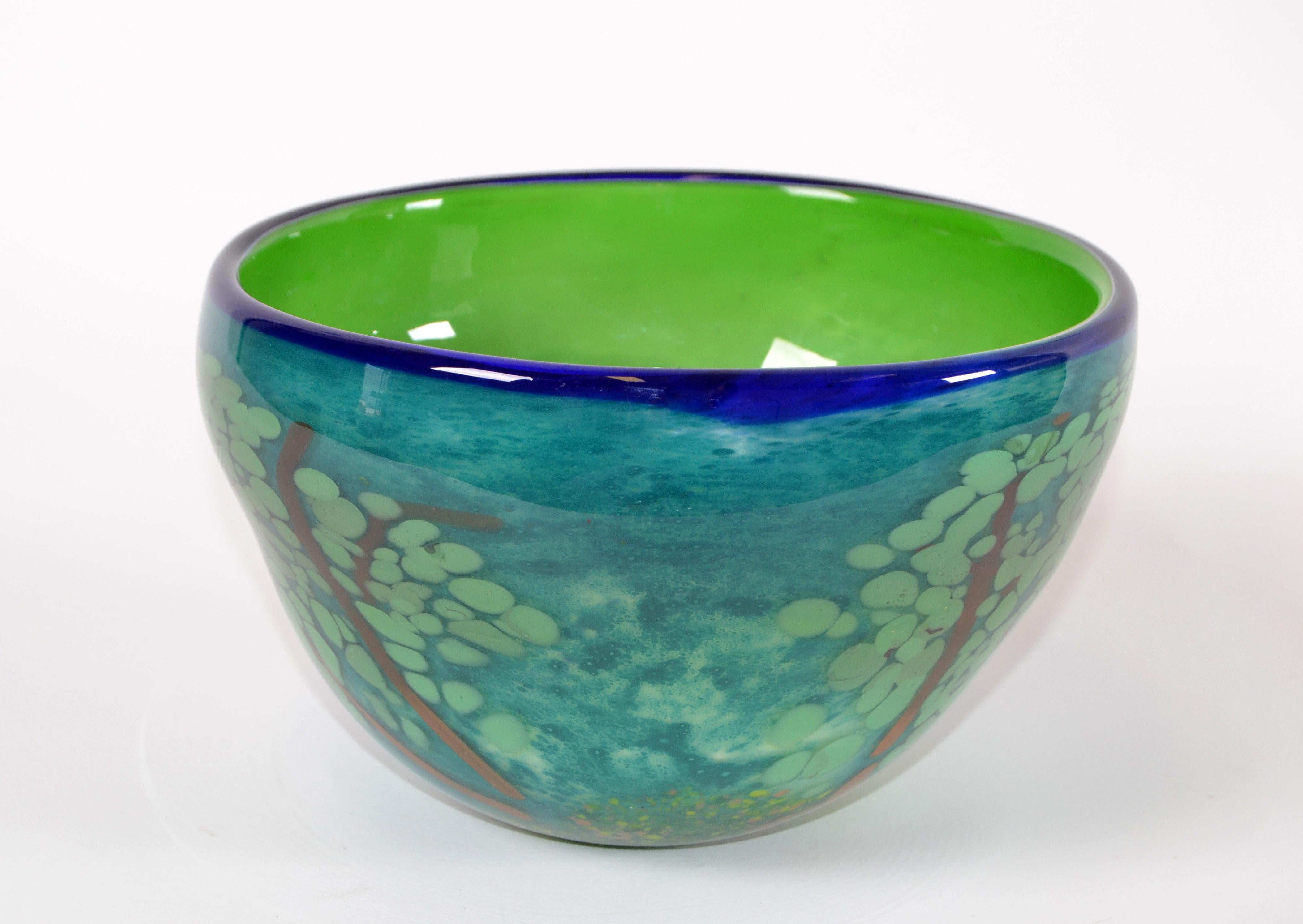A heavy Mid-Century Modern handmade art glass centerpiece or fruit bowl.
Rich green and blue coloring depicts a tree with leaves on each side in 3D effect.
Great rare craftsmanship.
       