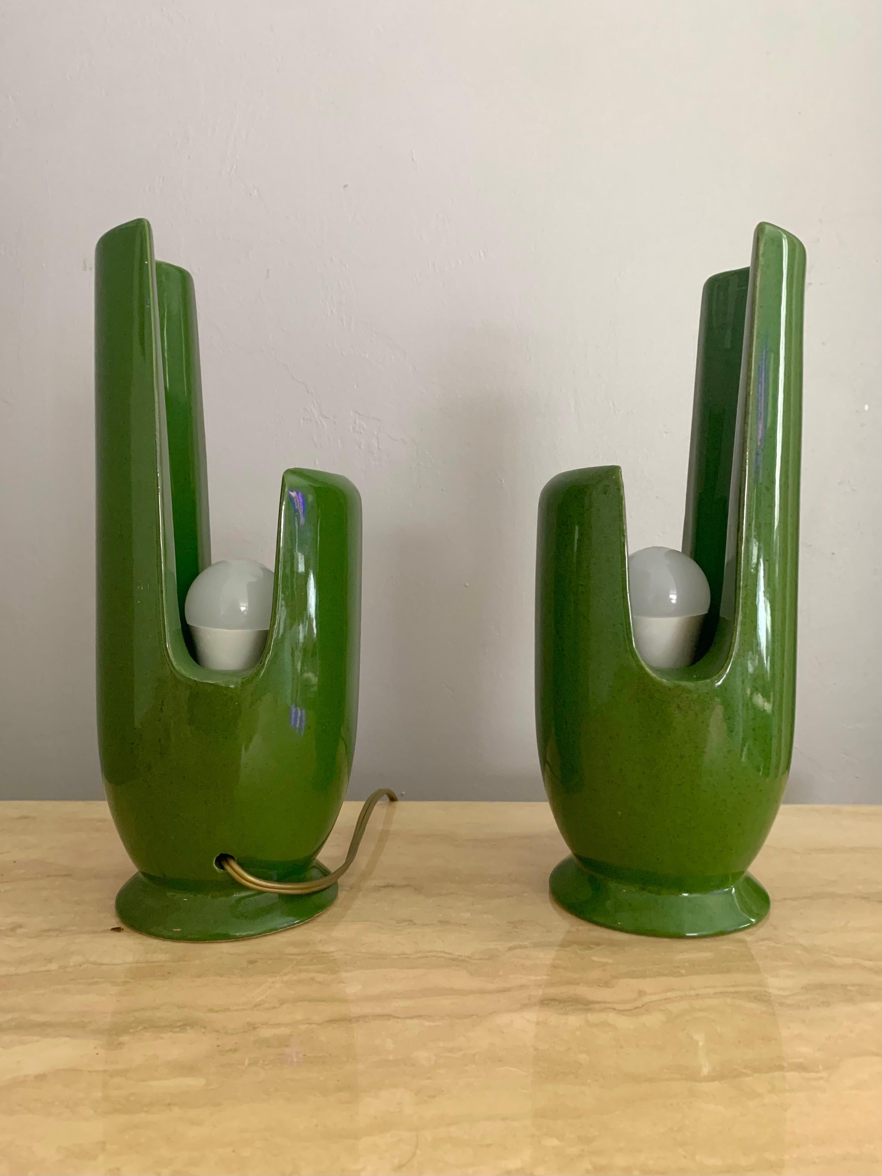 Beautiful and fun pair of ceramic lamps. Mid-Century Modern in design and era. Circa 1950s. The lamps have a playful organic and cubic shape which not only looks good but also allows you to direct the light depending on which way they are facing. If