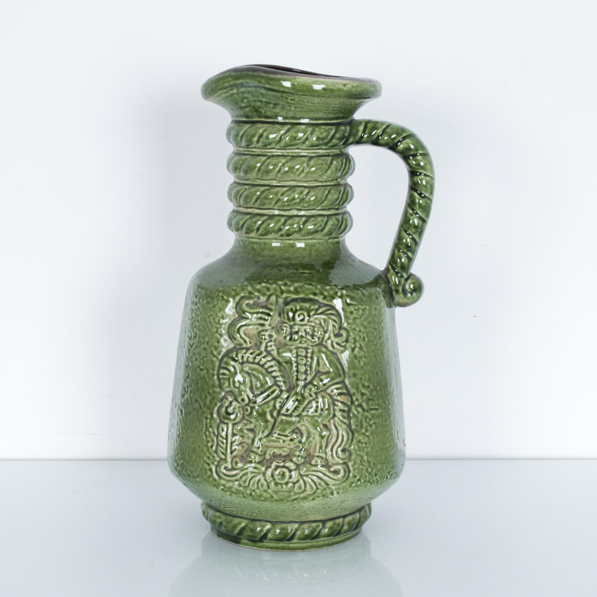 A graphic patterned vase produced by Carstens in Germany, circa 1950, adorned with a playful figure, and glazed in green, stamped on bottom with production series and “W. GERMANY” mark. These characteristic mid-20th century ceramics were produced in