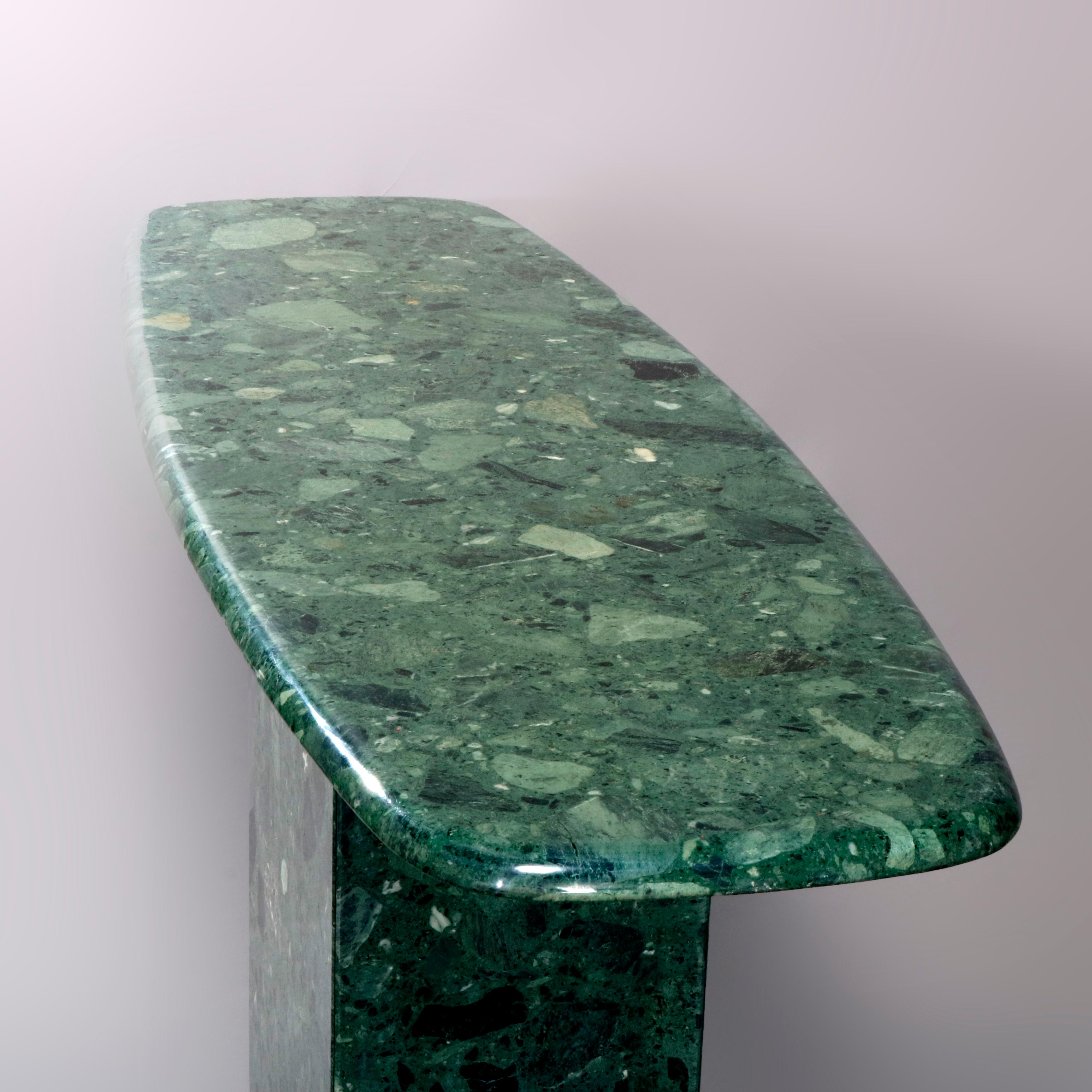 A Mid-Century Modern console table offers green granite construction with stylized oval surfboard form top surmounting square pedestal, circa 1960

Measures: 29.75