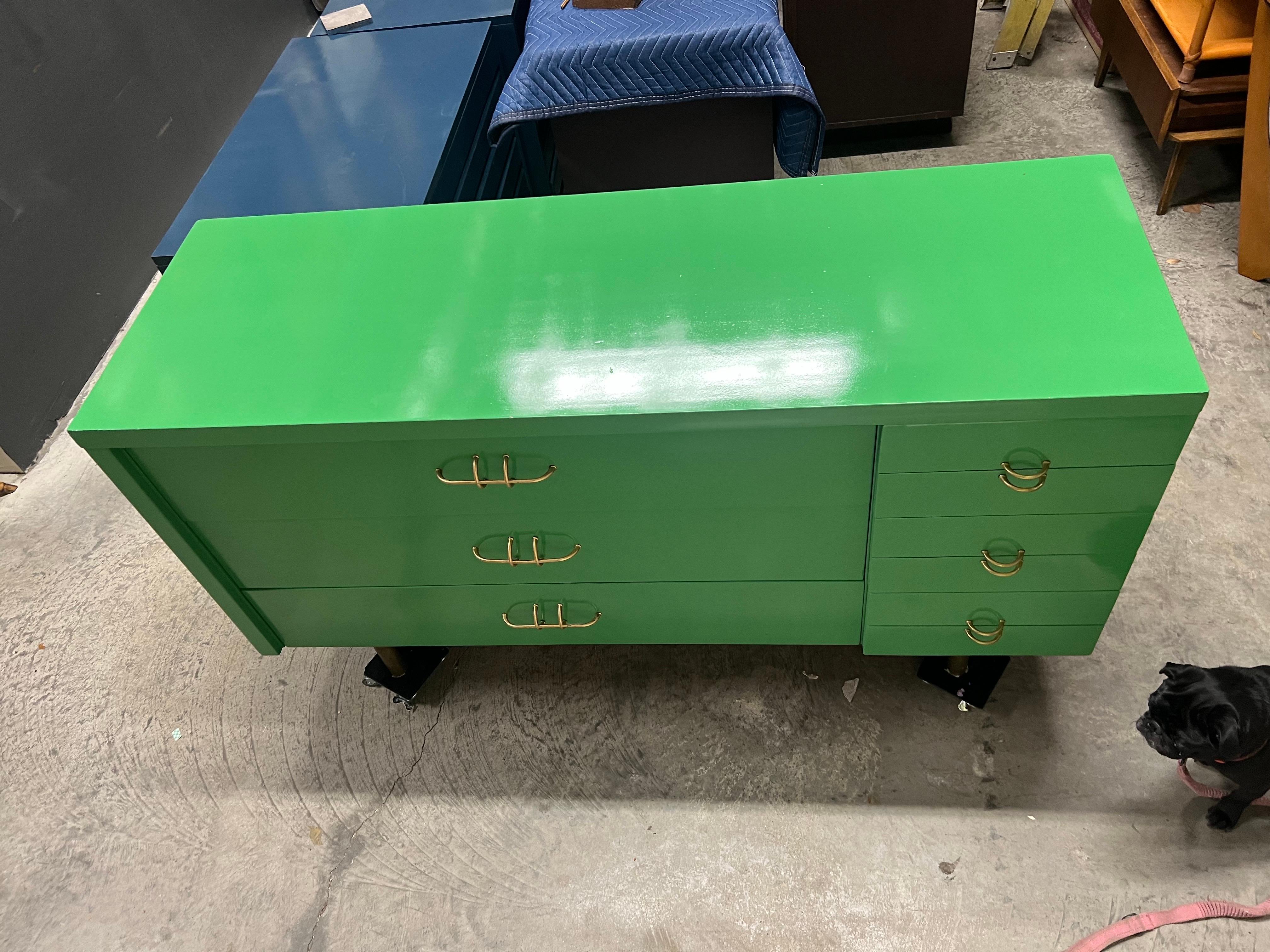 This dresser is unique from top to bottom.  Very interesting pulls in brass on the left, opening 3 large drawers.  On the right there are small “u” shaped pulls that are used to open smaller sized drawers.  The right drawers are different sizes and