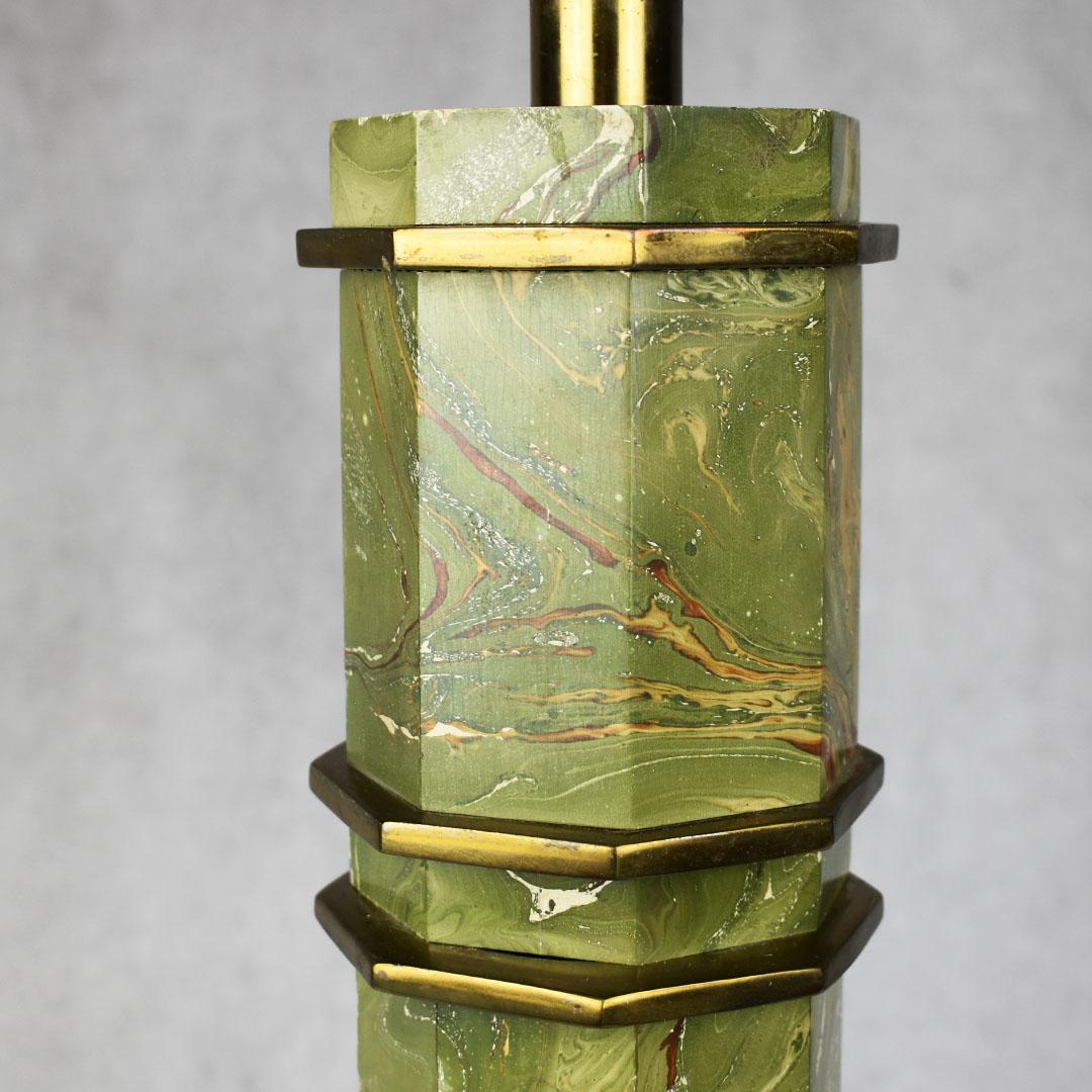 Tall green pagoda malachite look table lamp. A tall piece of lighting, this lamp has been created to look like malachite stone. With marbled greens varying from dark to light yellow. The base itself is octagonal, with horizontal brass octagonal
