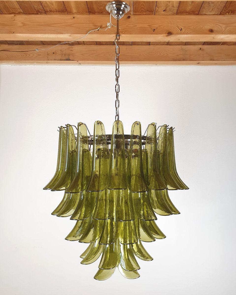 Mid-Century Modern five-tier Green Murano glass chandelier, by Mazzega, Italy, late 1970s.
The Vintage Murano chandelier is made of delicate handmade glass, and a chrome frame.
The chandelier has 7 lights, rewired for the US.
It creates a warm