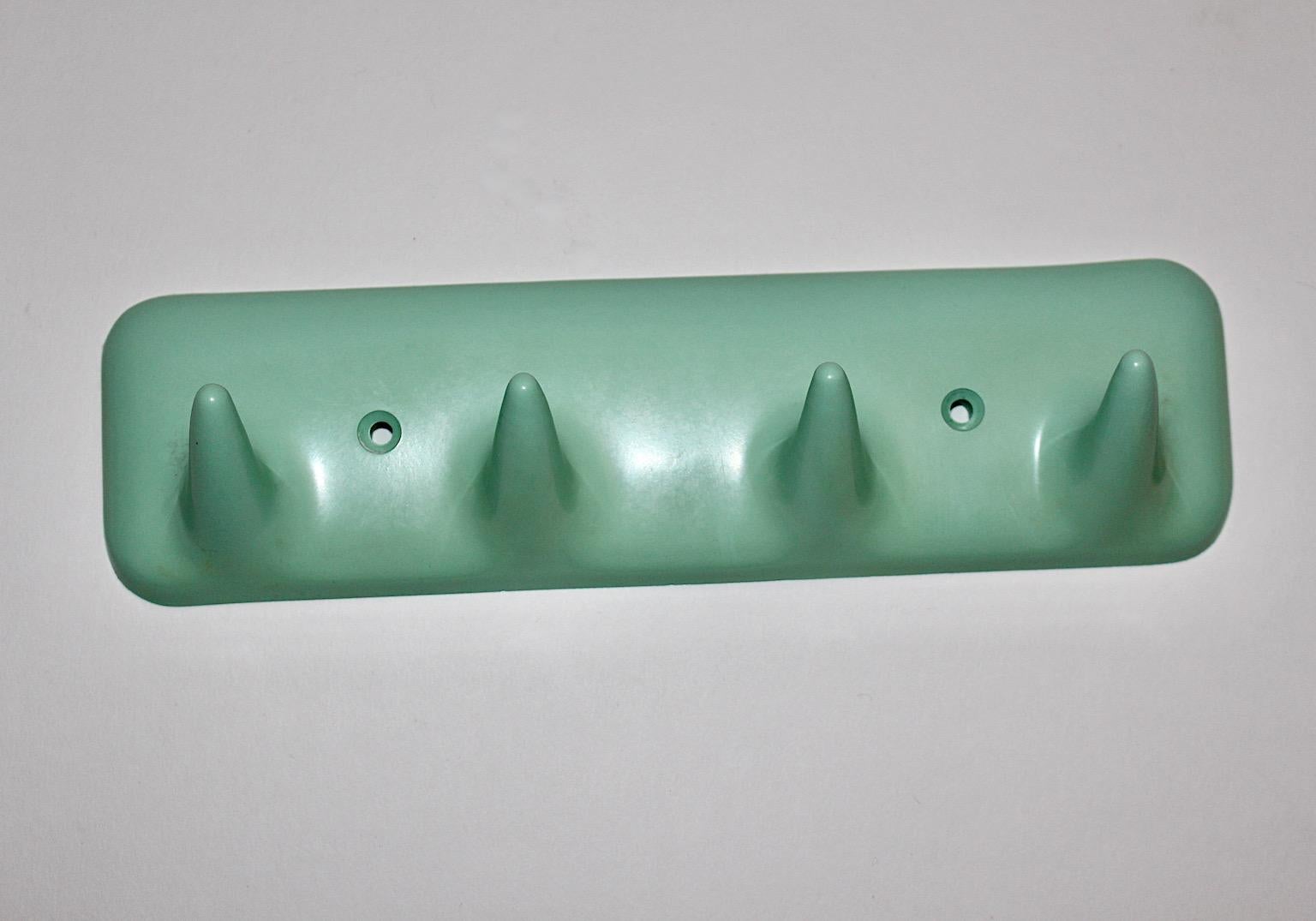 Mid-Century Modern vintage coat rack or wall hook from plastic designed and manufactured in Italy 1950s.
The green turquoise rail with 4 slightly curved hooks, which is easy to fix at the wall.
Stamped with CM Mod. Sesia brevettato Made in