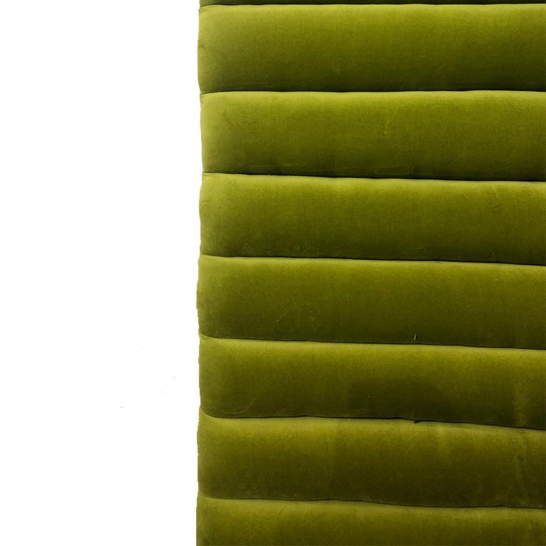 Green Mid-Century Modern wall-mountable velvet channeled headboard. The backing is made of wood and has no hardware. Should be affixed by decorator or handyman. Suitable for any size bed as the piece is meant to extend past the width of the bed.