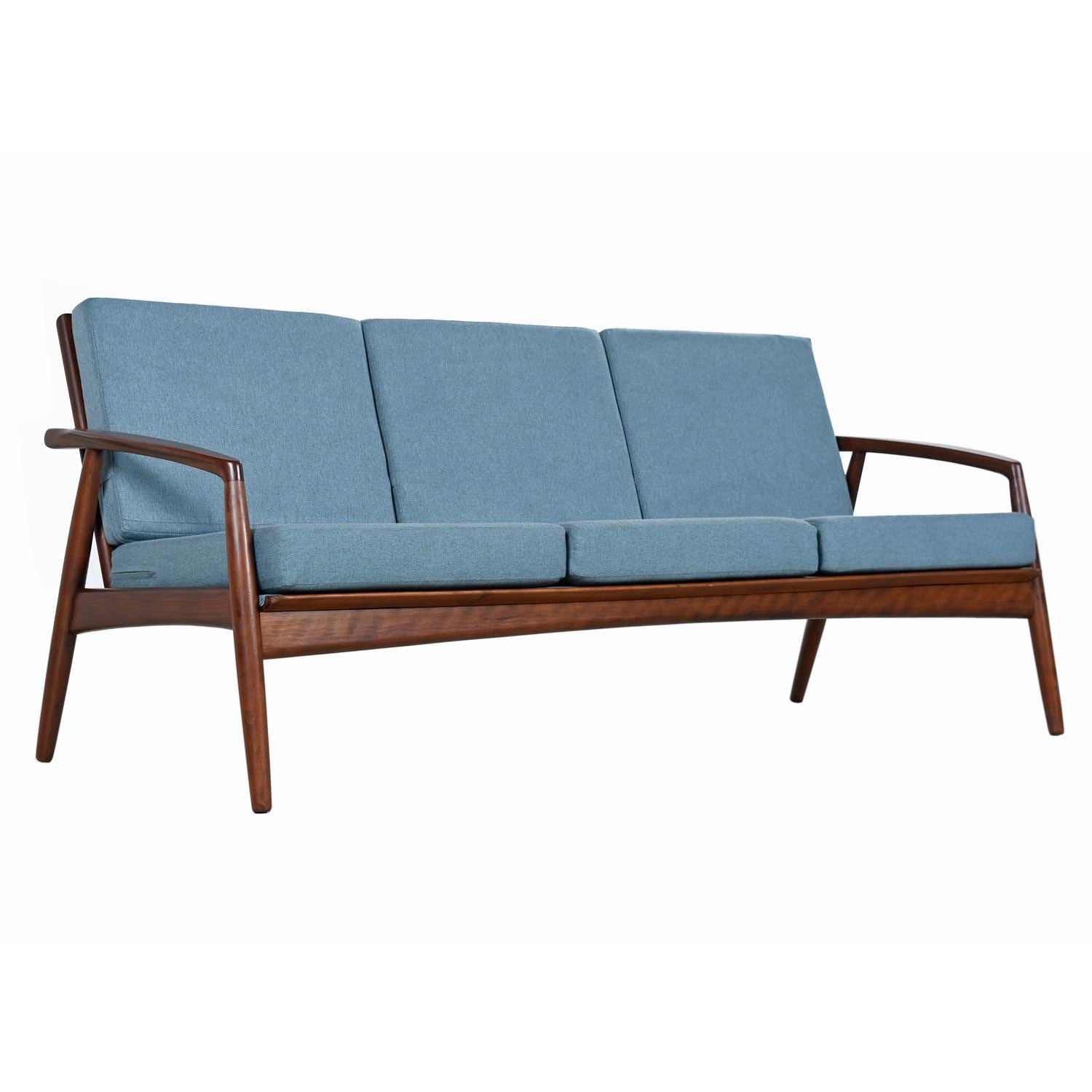 This stunning Danish made sofa by BOWA is one of the finest wood frame sofa’s we have seen from the period. Vintage early 1960s, SV.A. Madsen expands on the quintessential wood frame sofa to create something truly special. The arched arms are a