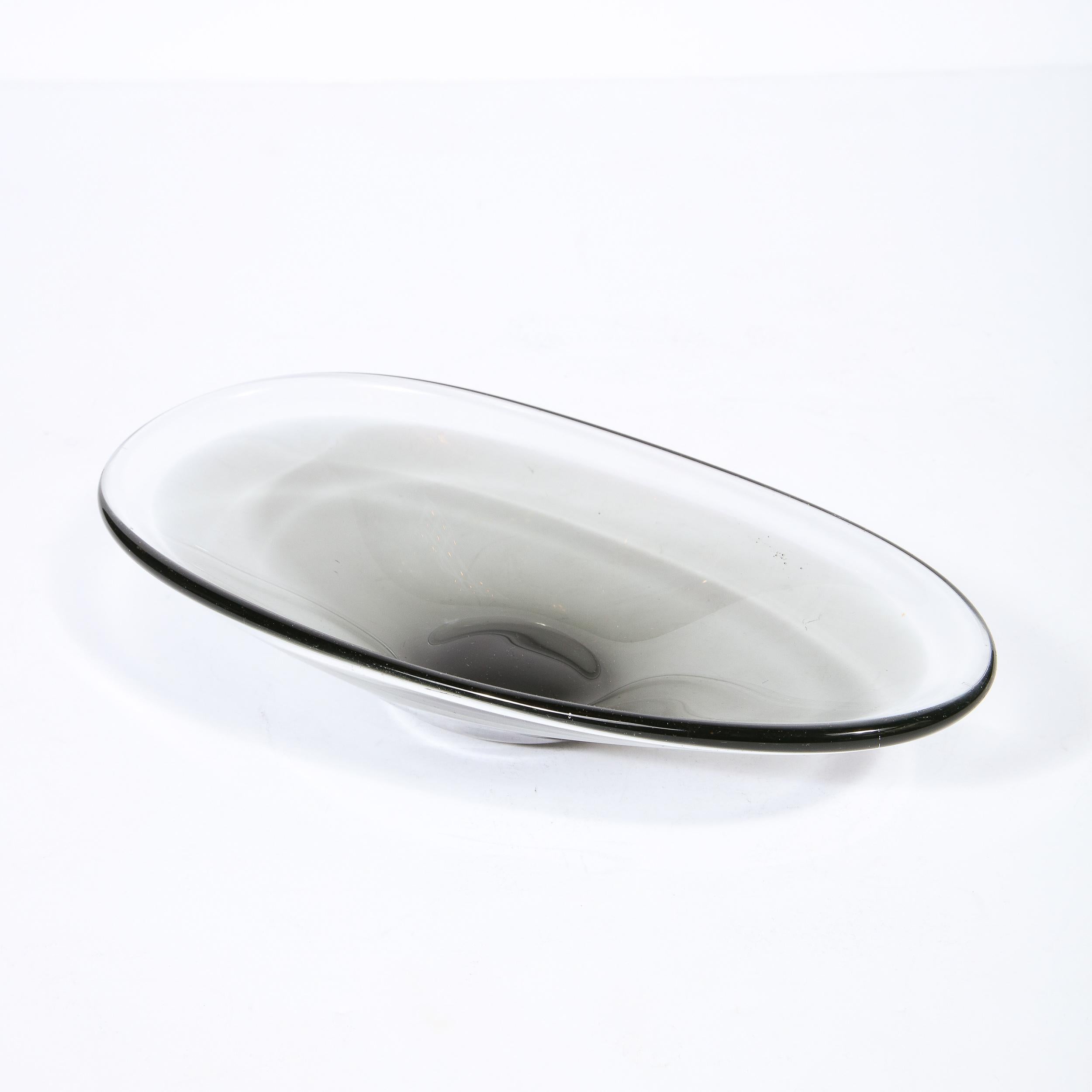 This stunning and graphic decorative bowl was handblown by the esteemed Scandinavian midcentury Studio, circa 1950. With its clean lines and amorphic form, this piece is as versatile as it is stunning blending perfectly with any style of interior