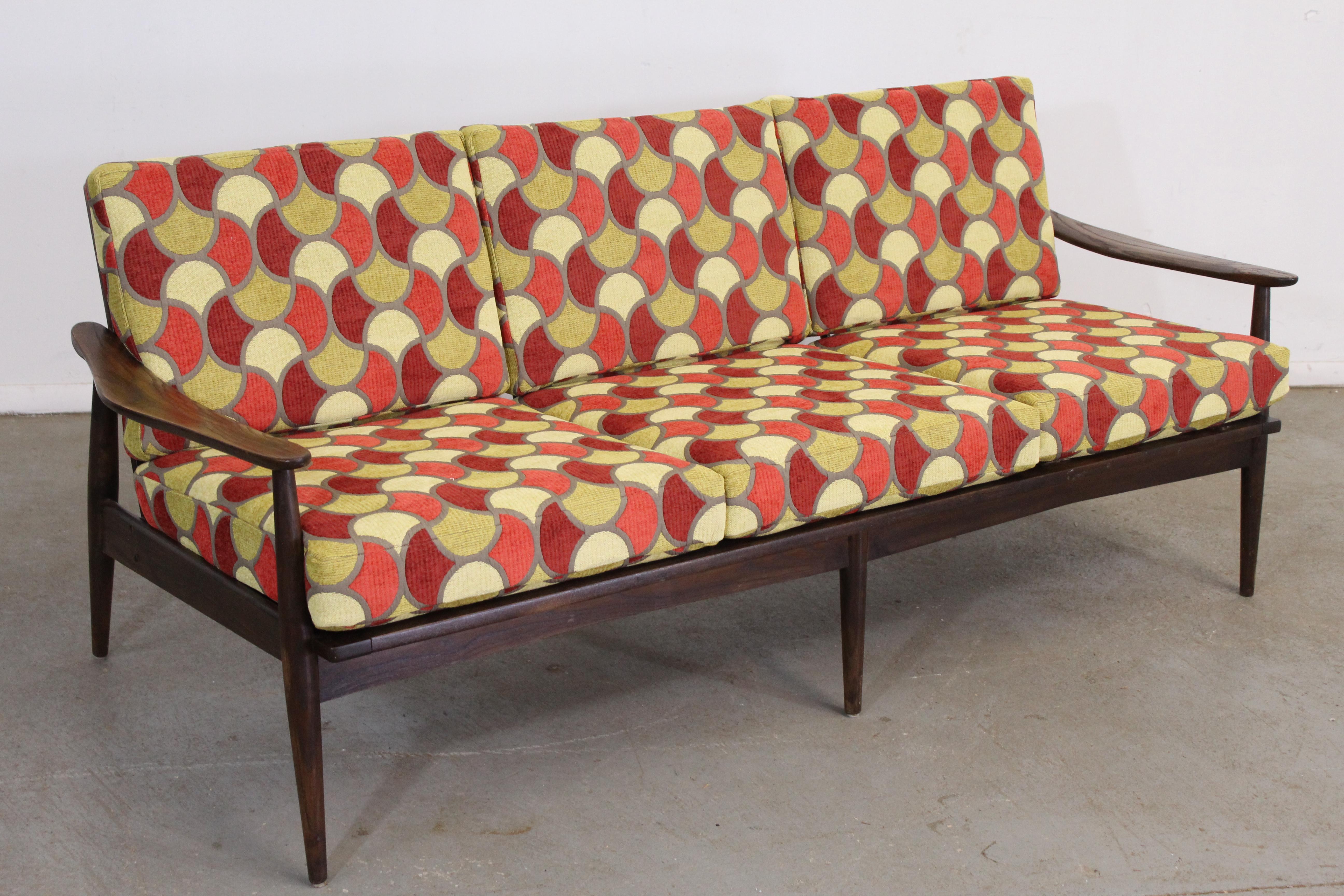 Mid-Century Modern geometric 3 cushion open arm walnut sofa
Offered is a restored Mid-Century Modern sofa. The sofa is in excellent condition and has been refinished and reupholstered. Features a period correct geometric pattern and new cushions.