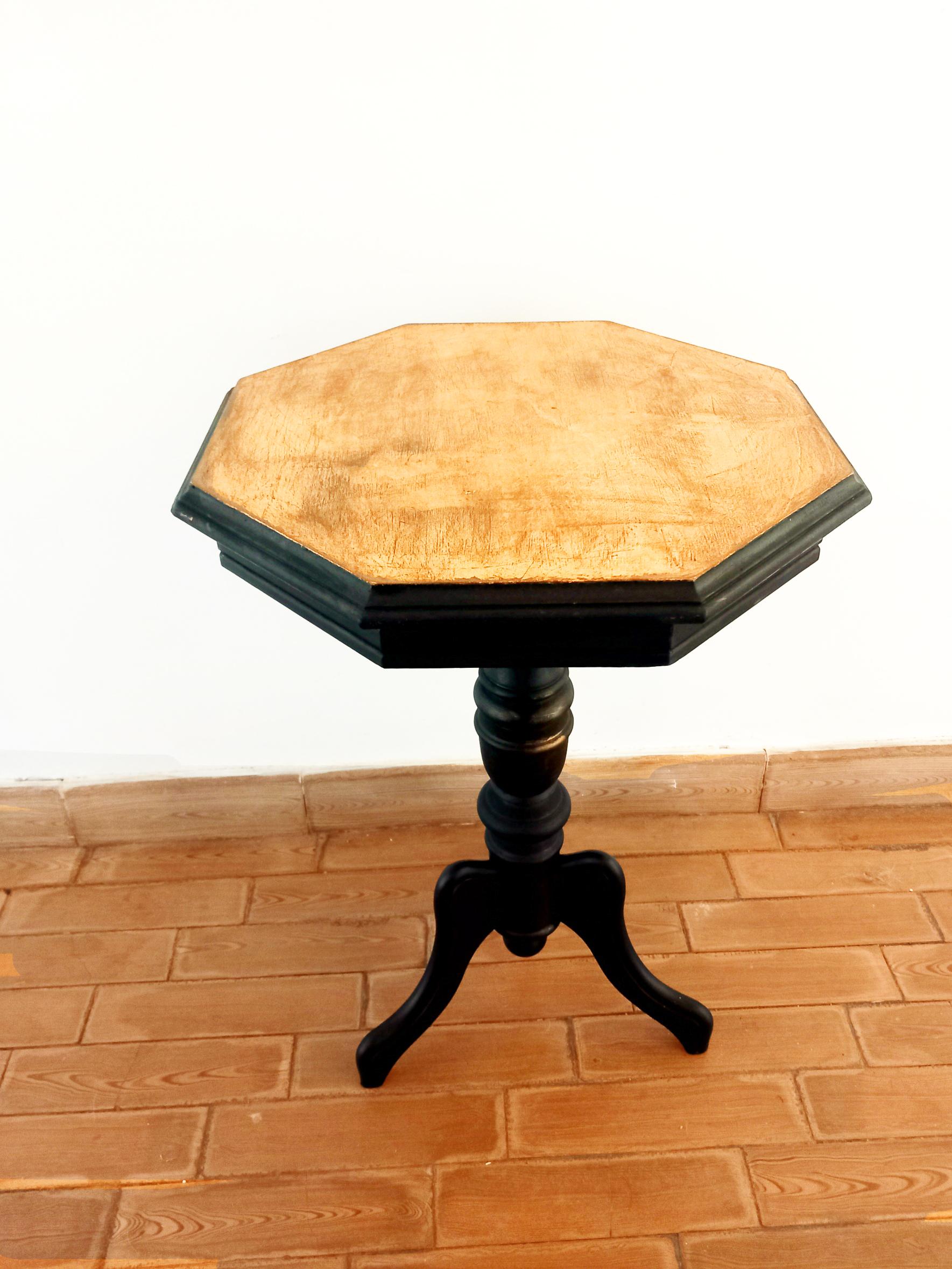 Gueridon or side table or ebonized wood and gold leaf on top
 Midcentury table in the form of an optogonal pedestal. It is a table or occasional table or wine table. It is very functional and decorative
 and it has a very modern design which is
