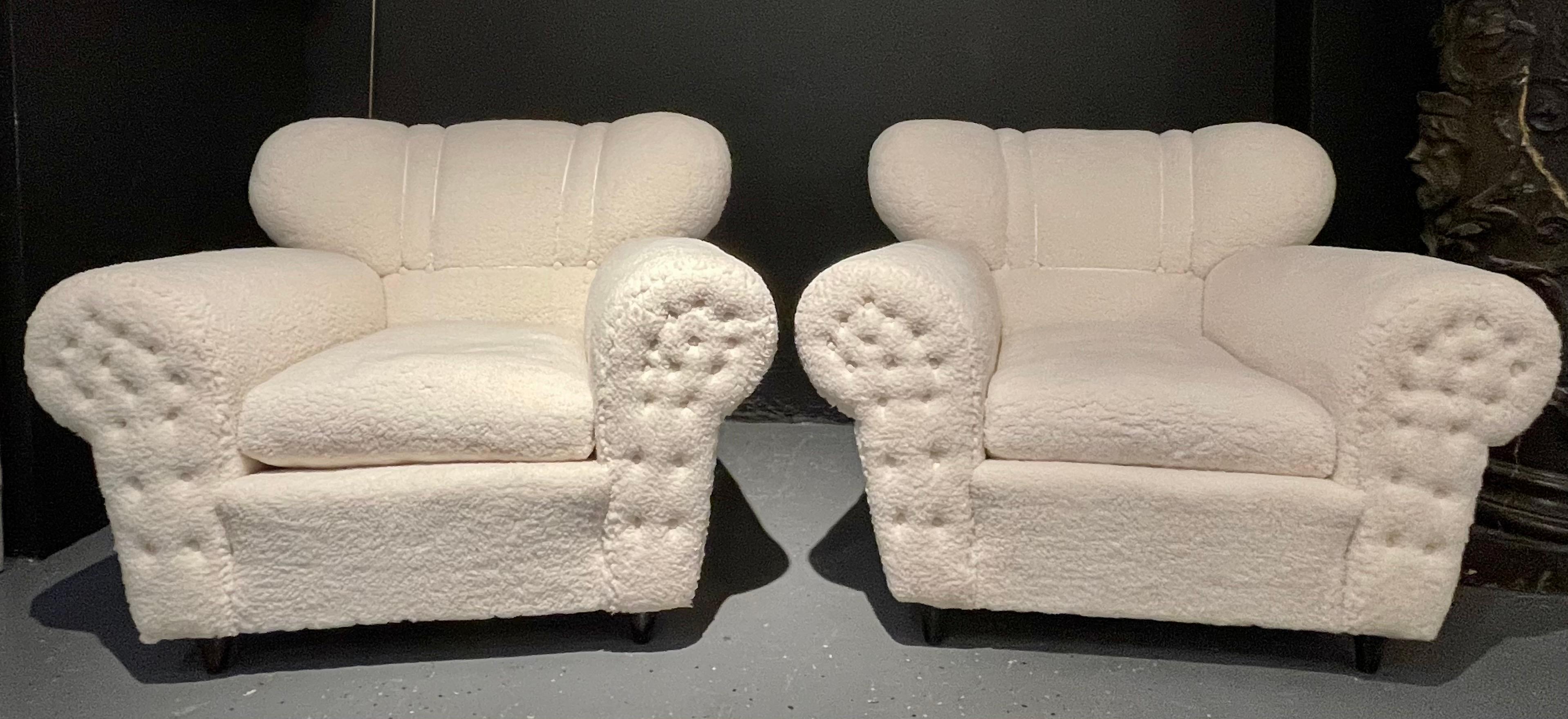 Italian Guglielmo Ulrich style lounge chairs. A fine pair from Italy circa 1940s. Upholstered in a plush Sherpa style fabric with painted wood. Unsigned. Sleek and stylish are these oversized pair of lounge chairs with tufted armrest fronts.