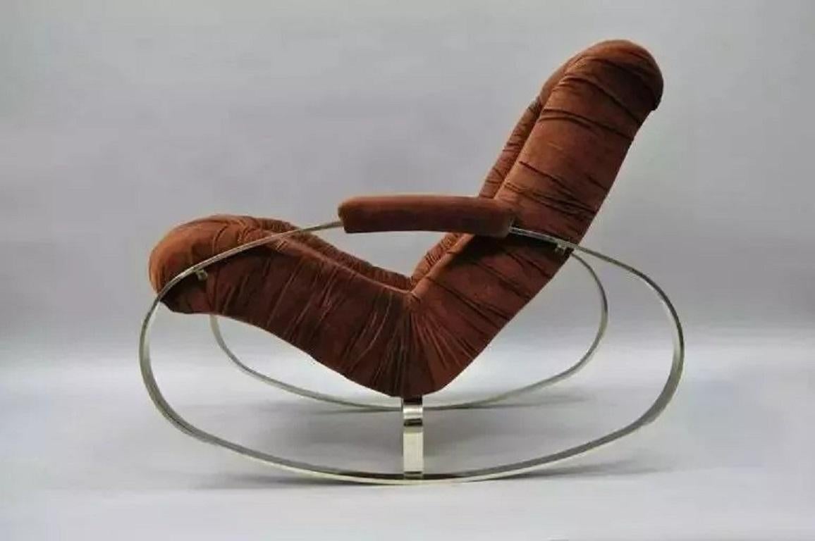 Mid Century Modern Guido Faleschini Chrome & Brass Milo Baughman Rocking Chair. Item features a heavy ovoid shaped steel frame with chrome/bronze finish, upholstered armrests, and original rust color fabric. Circa Mid 20th Century. Measurements: 36