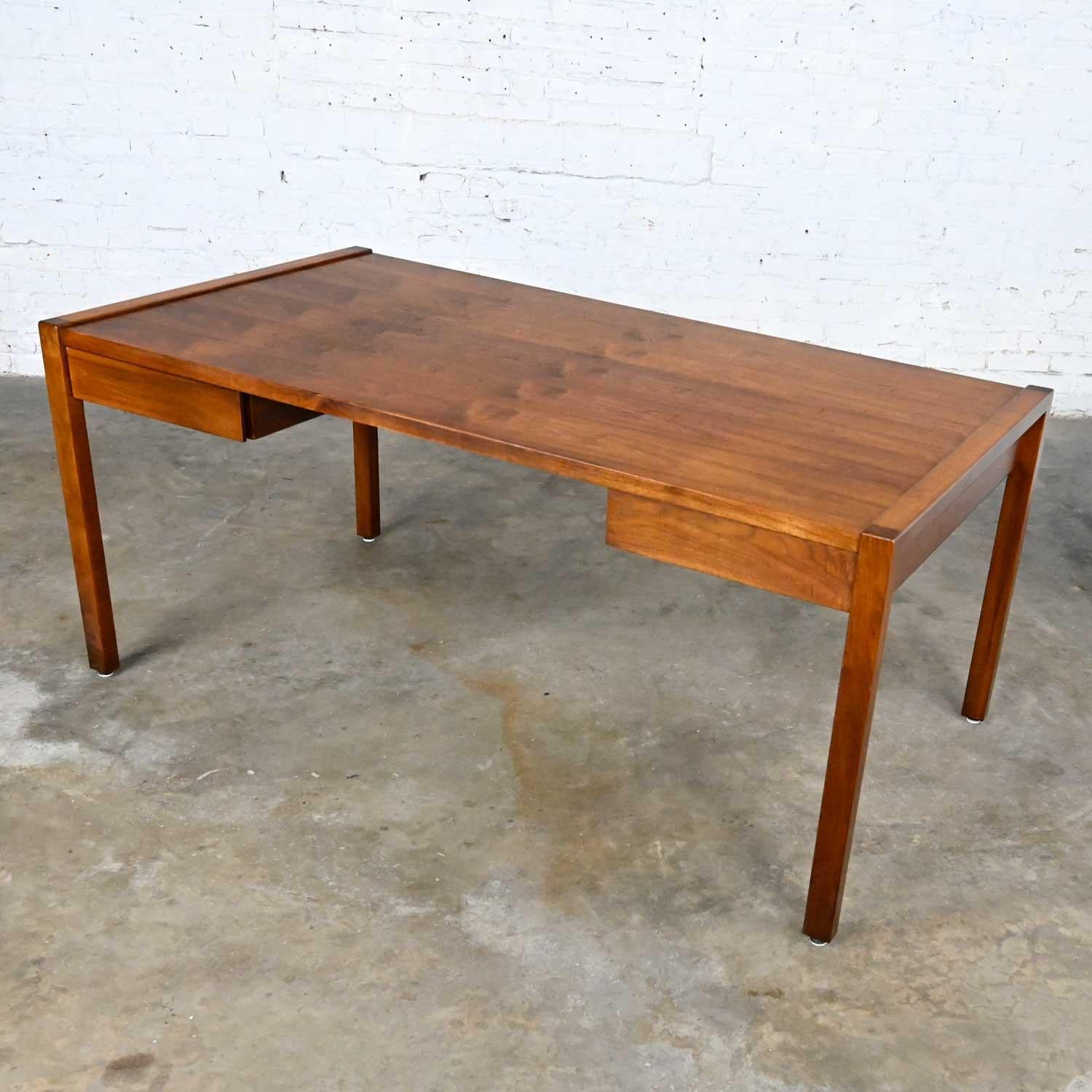 Gorgeous Mid-Century Modern Gunlocke executive walnut desk with a modified Parsons style. Beautiful condition, keeping in mind that this is vintage and not new so will have signs of use and wear. The front left leg has had a missing piece filled and