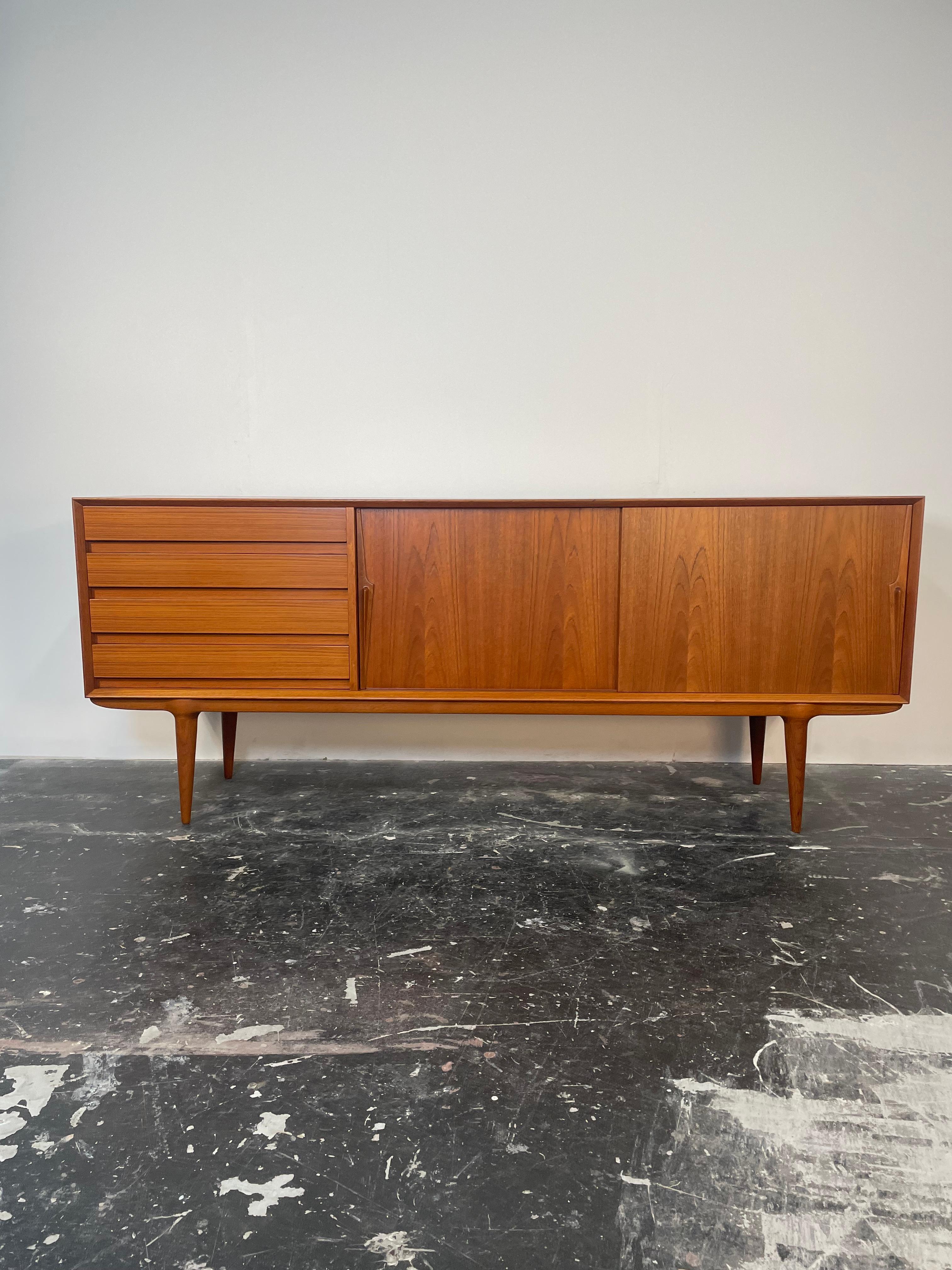 A vintage teak credenza by Gunni Omann, 'Model 18' made in teak.

Omann Jun Møbelfabrik (founded in 1933 by Andreas Omann), produced some of the most iconic Danish designs of the 1950s and 1960s. Originally produced in the 1960s, this Model #18