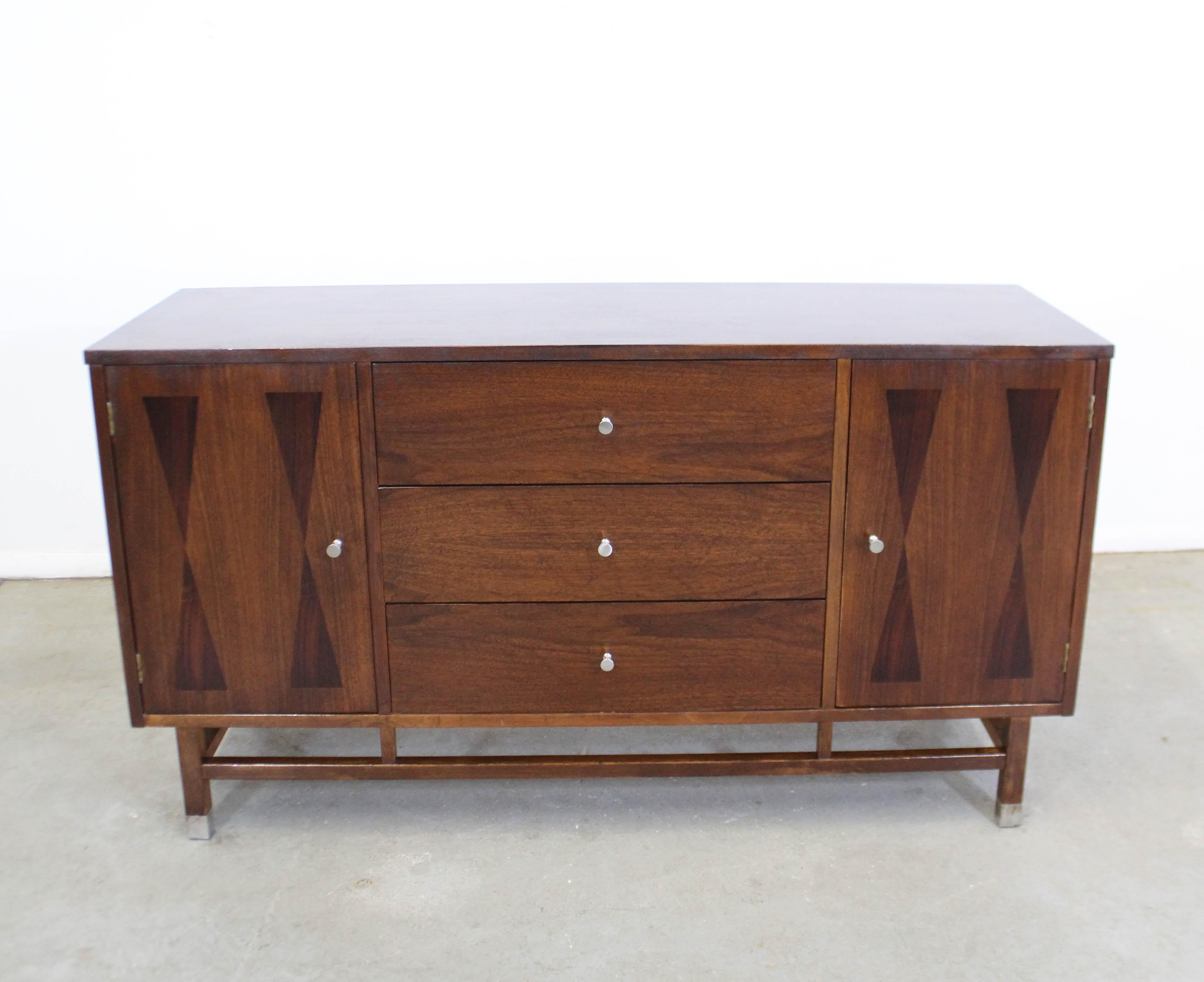 Midcentury Danish modern H. Paul Browning Stanley Petite walnut credenza

Offered is a vintage American Mid-Century Modern walnut credenza/sideboard by H. Paul Browning for Stanley Furniture. The simple design features darker wood inlays on the
