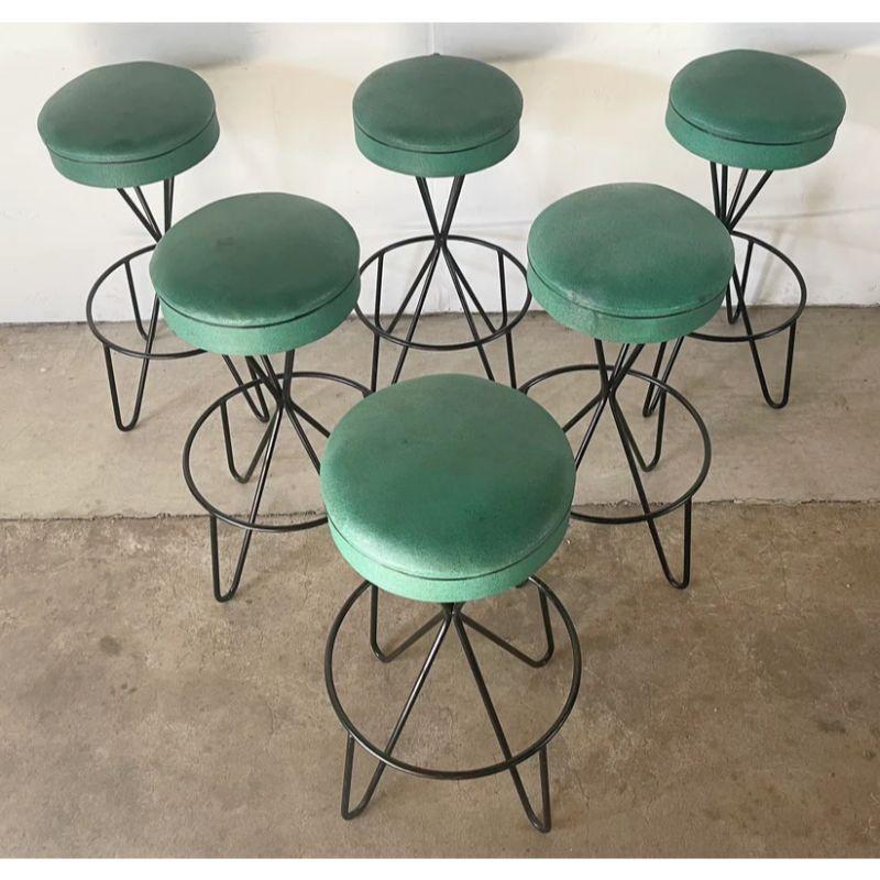 This impressive set of six swivel barstools feature green vinyl seats and black hairpin leg bases. The matching set of six stands 32 inches tall and are well suited to bar height counters. Heavy construction and iron base make this swivel barstool