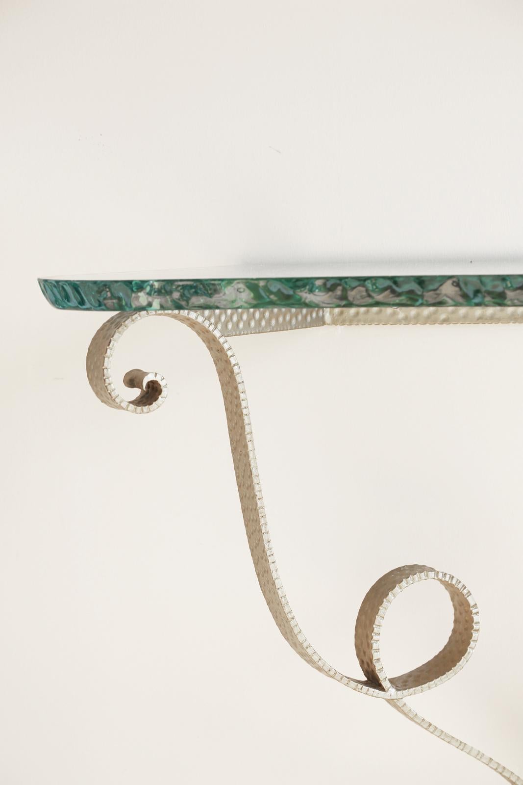 Wall mounting console, of heavy-gauge, hammered and silvergilt brass, having its original, serpentine top of one-inch 