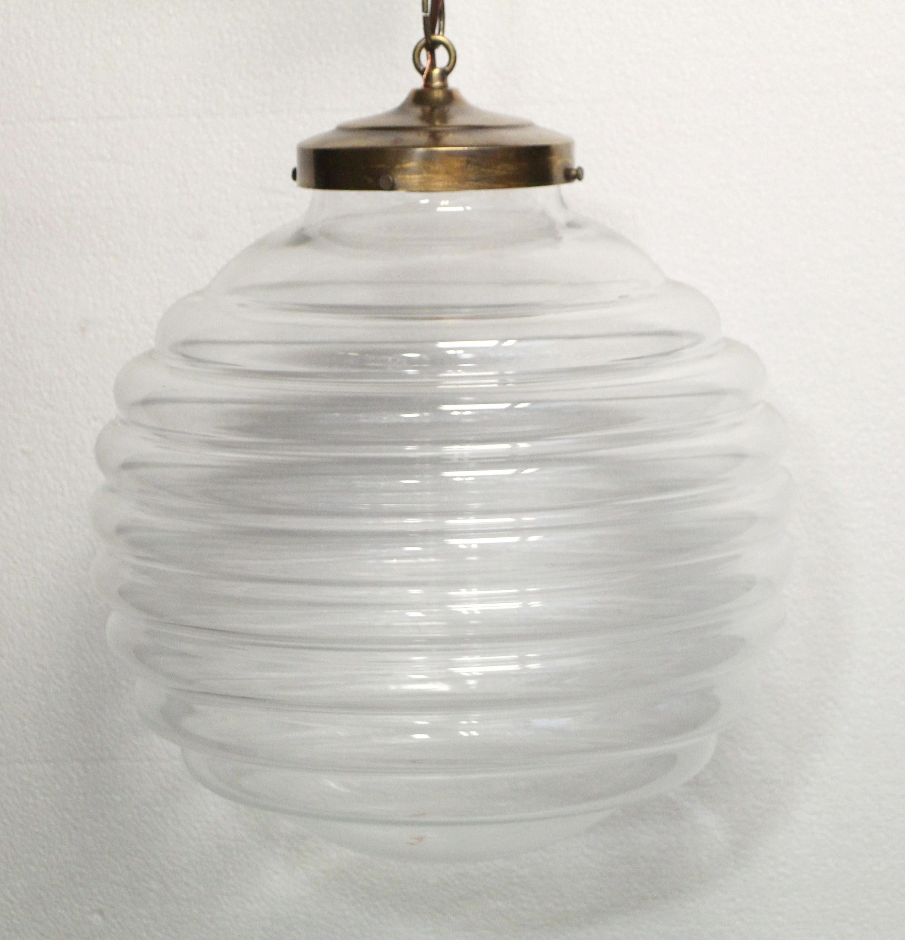 Large beehive shaped pendant light made of hand blown Italian crystal done in a Mid-Century Modern style. The fitter with chain is done in an antique brass finish. This can also be made in nickel or brushed steel finish, with a chain or pole of your