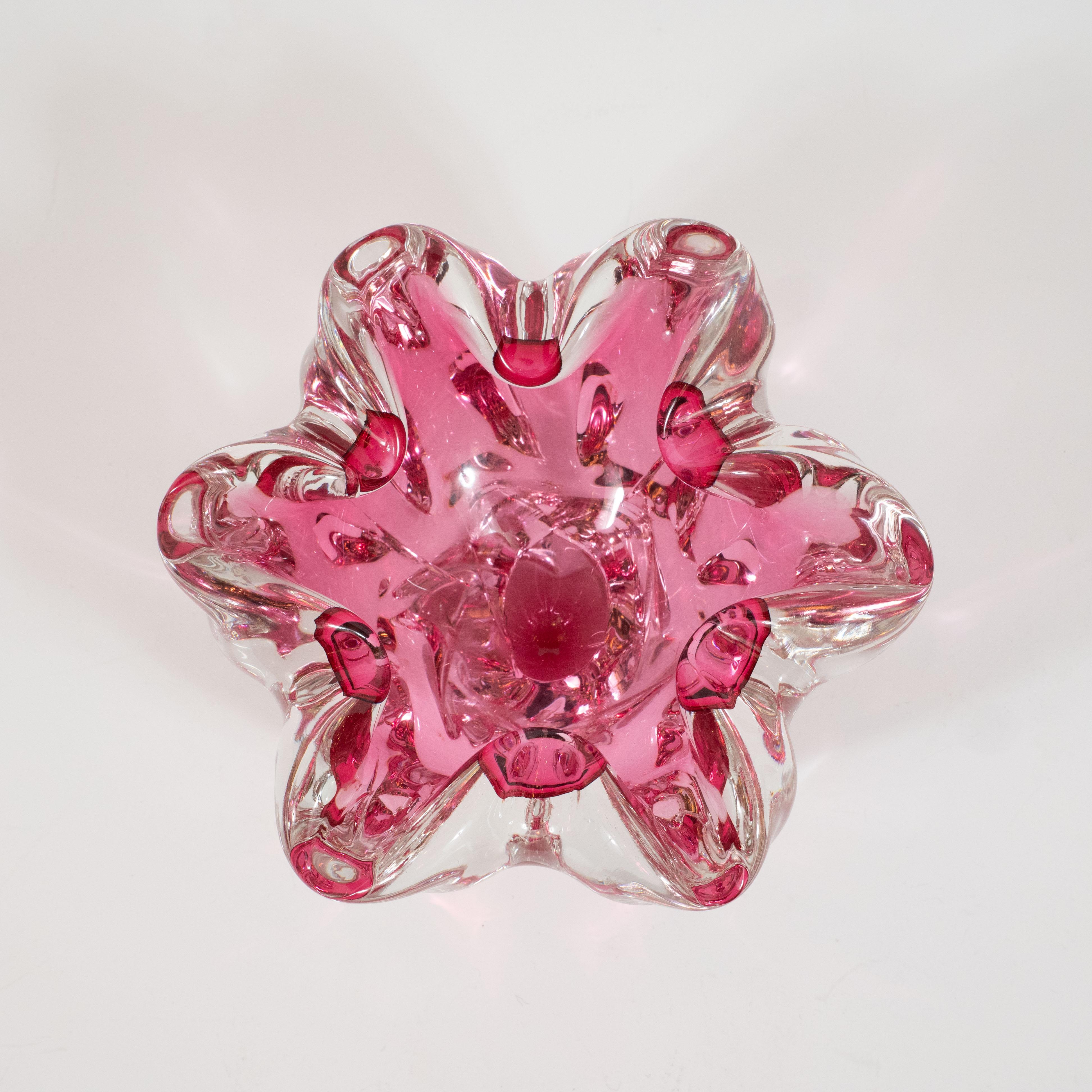 This beautiful Mid-Century Modern dish was hand blown in Murano, Italy, the island off the coast of Venice centuries renowned for its superlative glass production, circa 1960. The dish consists of an inner magenta layer and an outer translucent