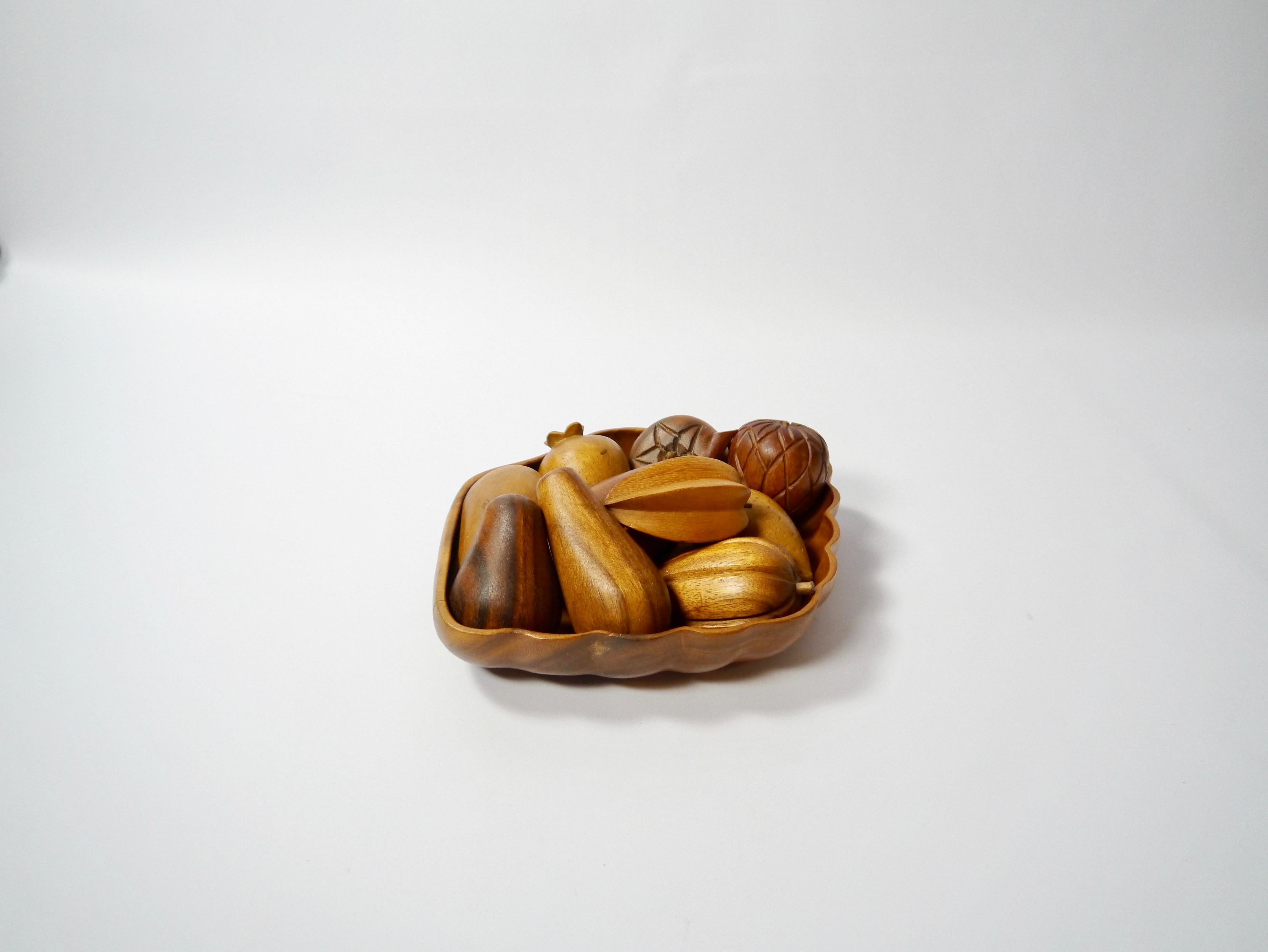 Set of 10 hand carved wooden fruits with bowl. High level of craftsmanship, executed in a handful of different hardwoods.