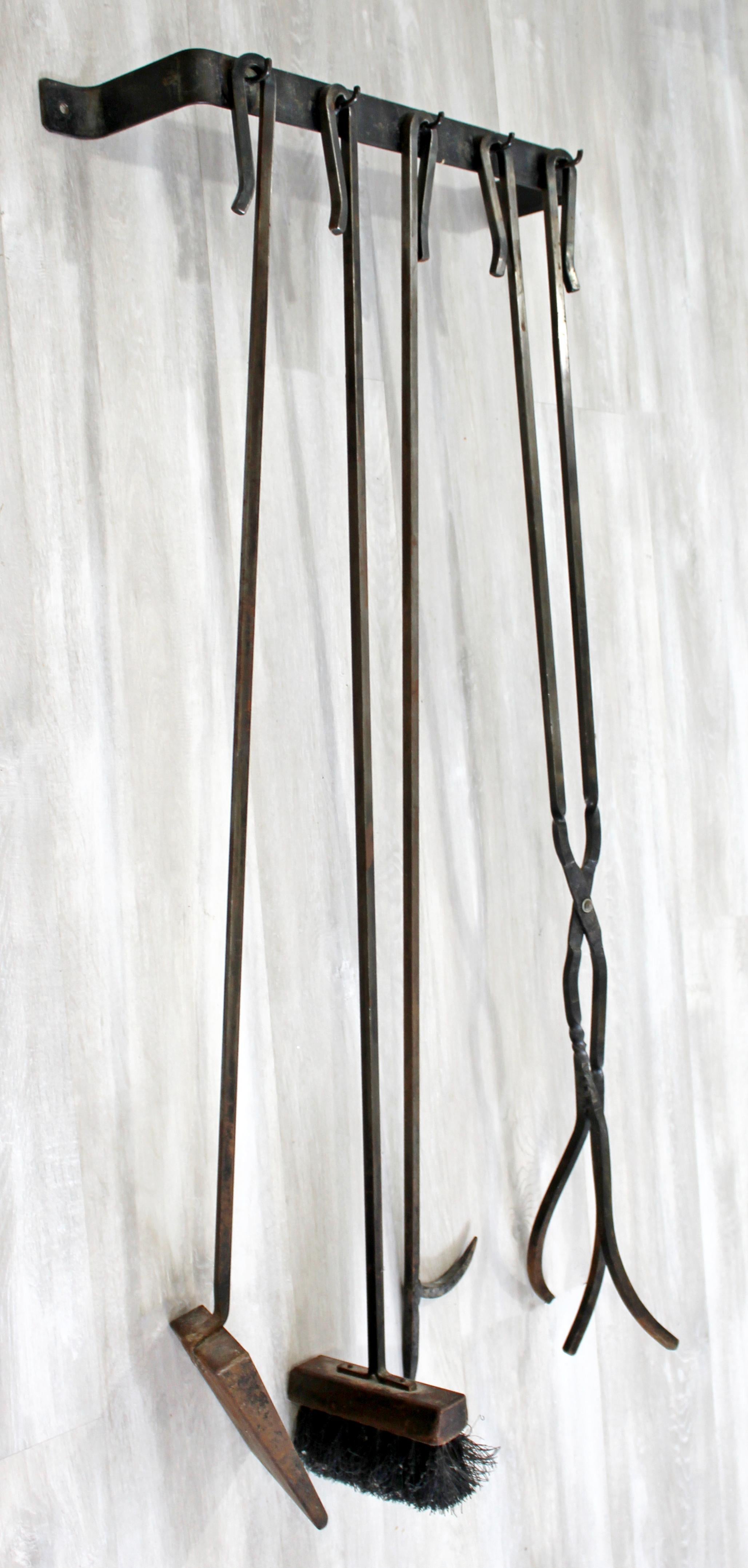For your consideration is a handsome, hand forged set of iron fireplace tools, including a shovel, brush and poker, circa 1960s. In very good vintage condition, with a patina to match its age. The dimensions are 21.5