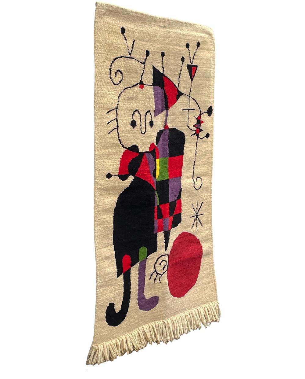 A beautifully crafted wall tapestry after Joan Miro. It features hand knotted wool construction with vibrant colors. Clean and ready for use.