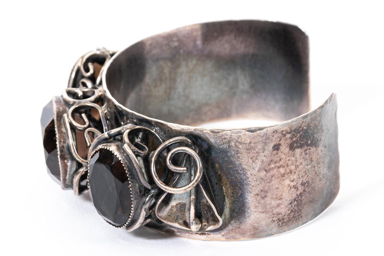 Circa 1950s hand made sterling silver and smokey quartz cuff bracelet in the Mid-Century Modern style. The piece is signed 