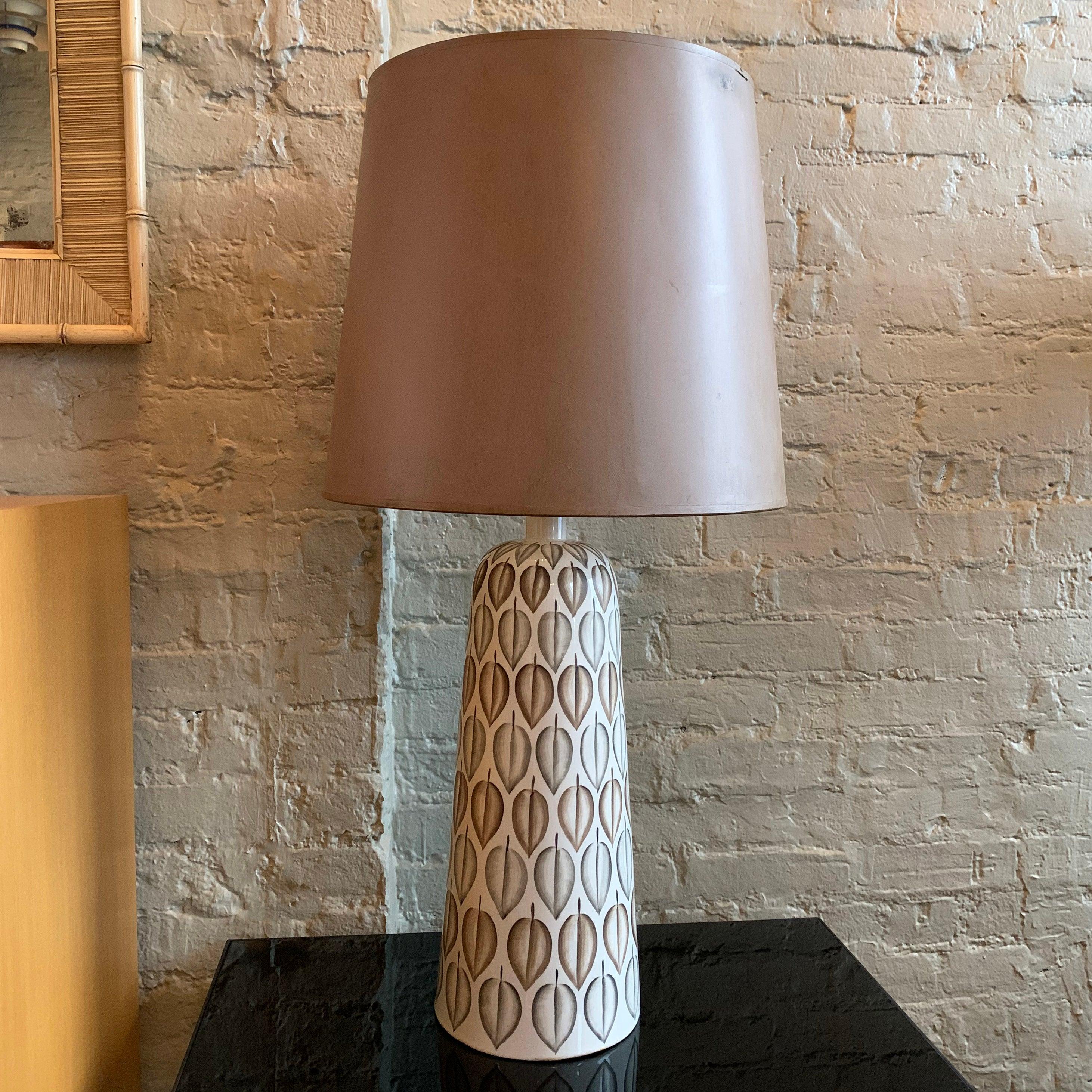Mid-Century Modern, art pottery, table lamp features hand painted leaves on a ceramic base with milk glass under shade that the original, brown shade with reflective interior rests on. Lamp height without the shade is 27 inches.