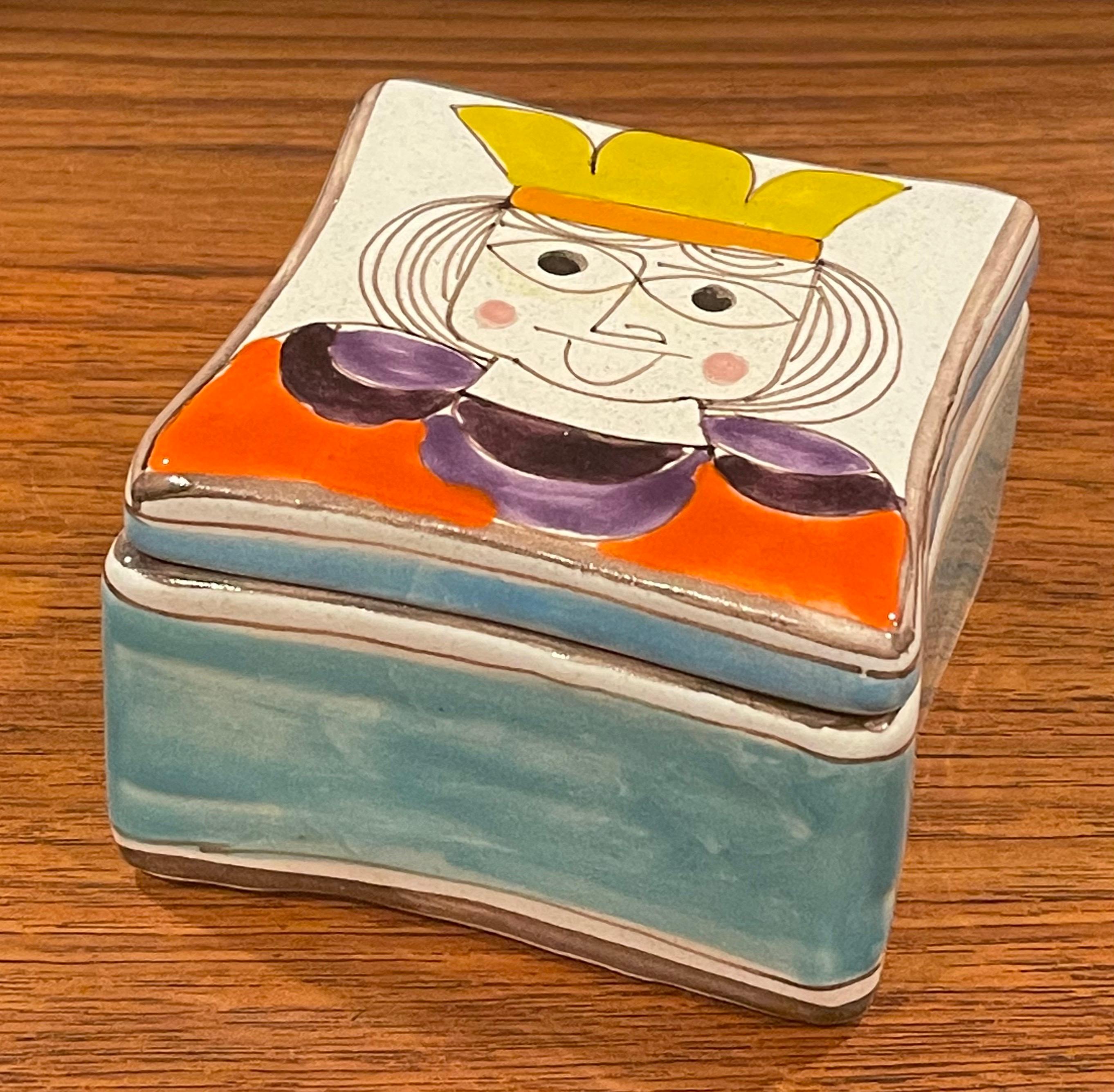 A wonderful and colorful Giovanni Desimone hand painted lidded trinket box, circa 1970s. The handcrafted ceramic box was made in Italy and measures 4.4