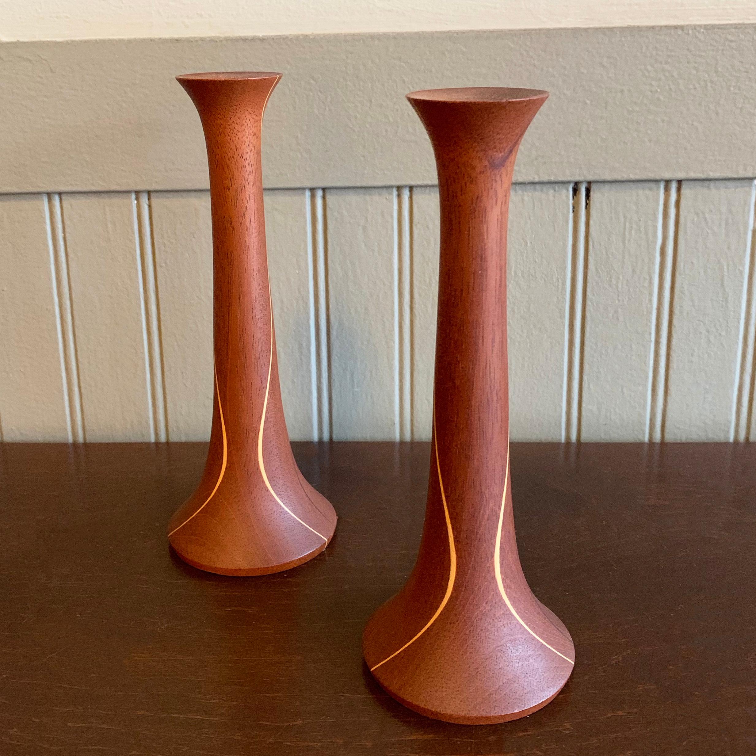 Lovely pair of Mid-Century Modern, hand-turned teak candlestick holders with contrasting inlaid pattern.