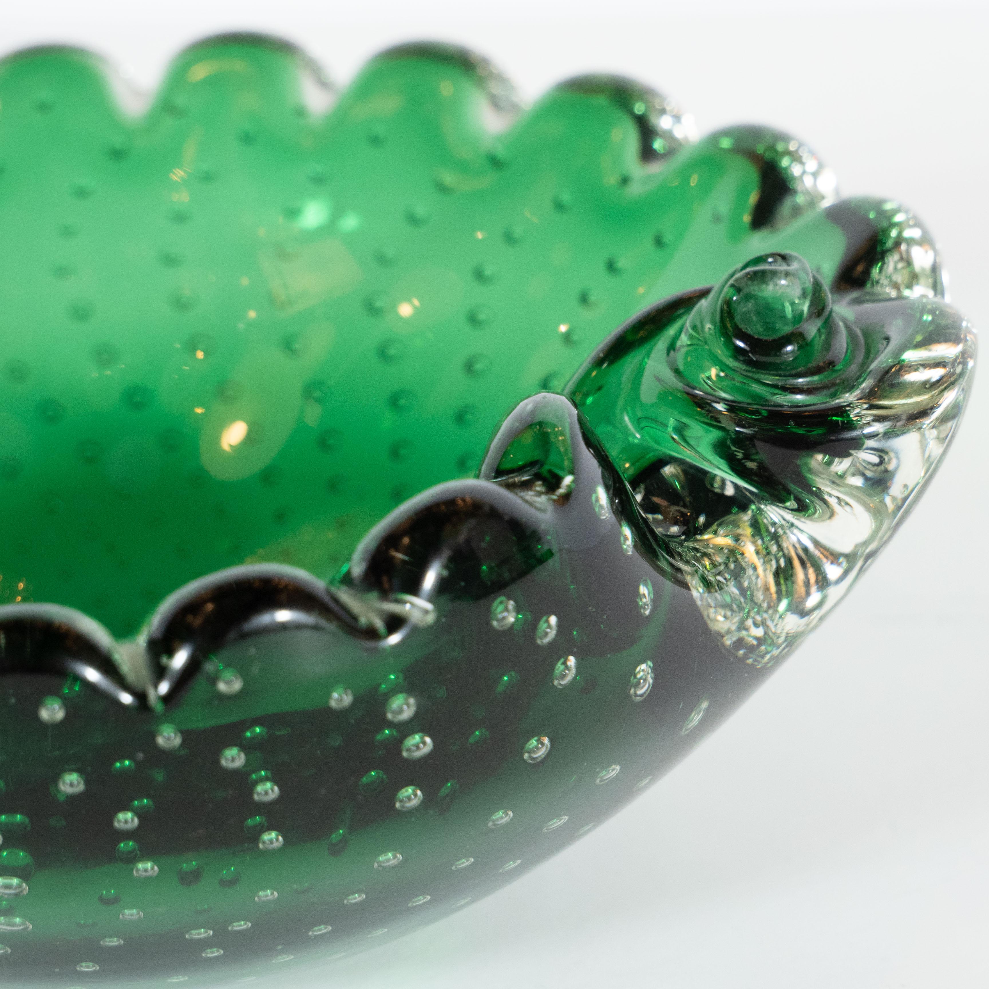 This elegant glass bowl was handblown in Murano, Italy - the island off the coast of Venice centuries renowned for its superlative glass production- circa 1960. Resembling a leaf, the asymmetrical rim of the bowl has scalloped edges and offer a